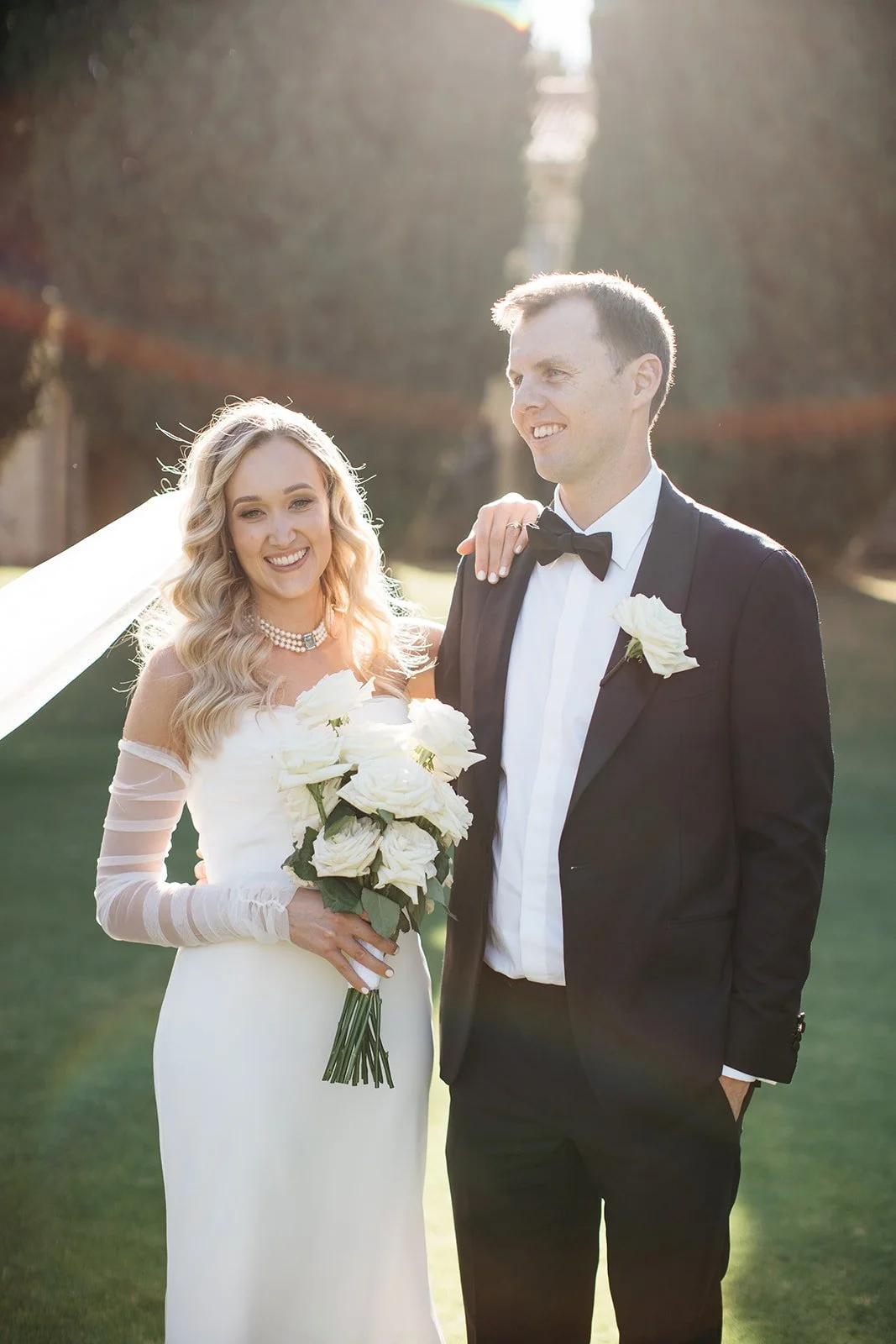 Hannah and Justin with a white rose wedding bouquet at Matilda Bay in Perth
