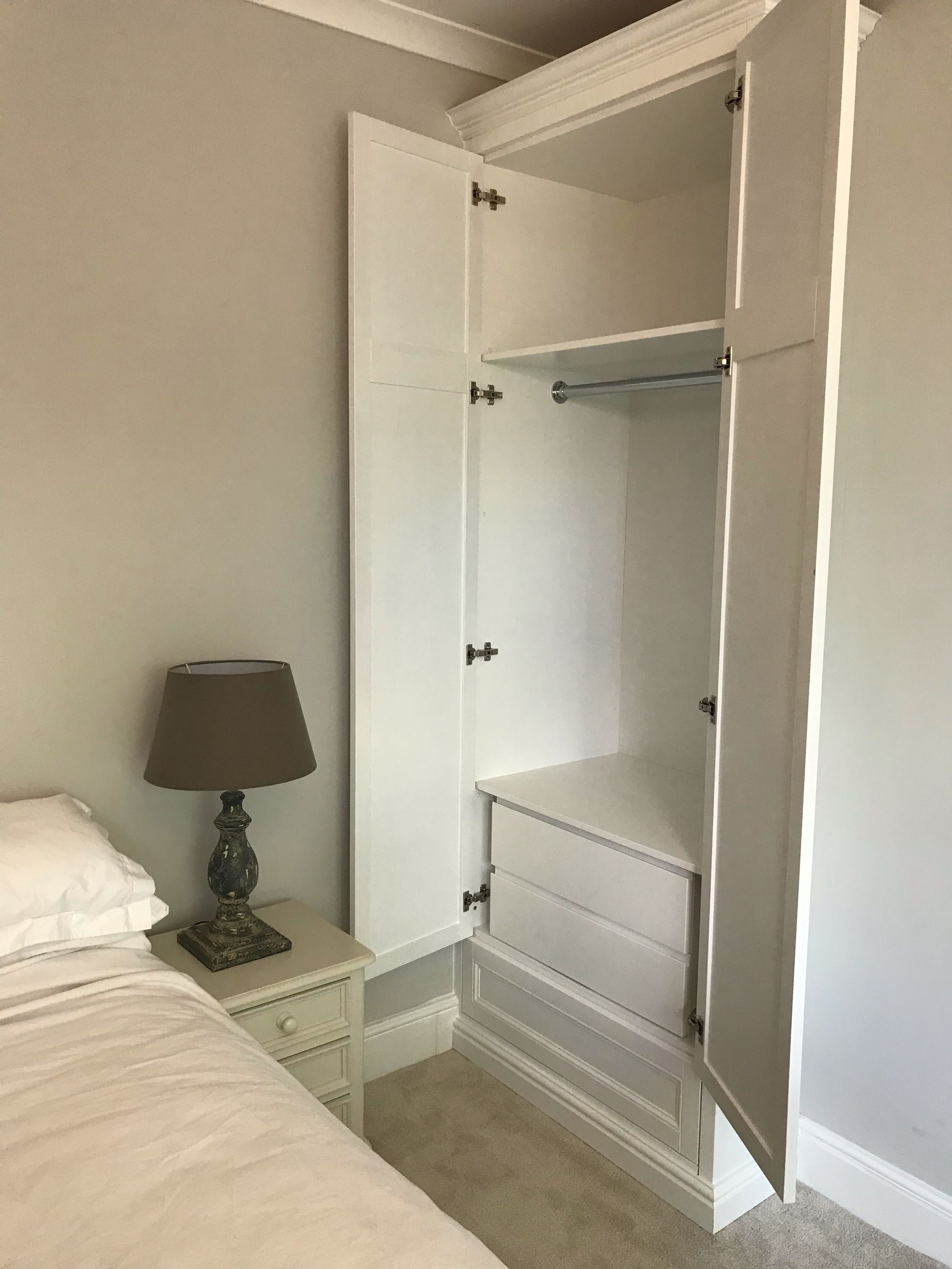  Bespoke Wardrobe in bedroom with integrated drawers and hanging rail  