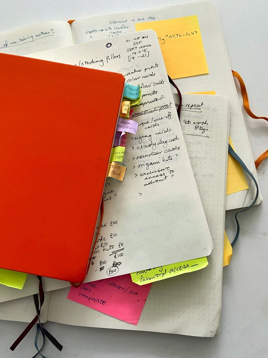 Piles of notebooks on a desk full of ideas and writing