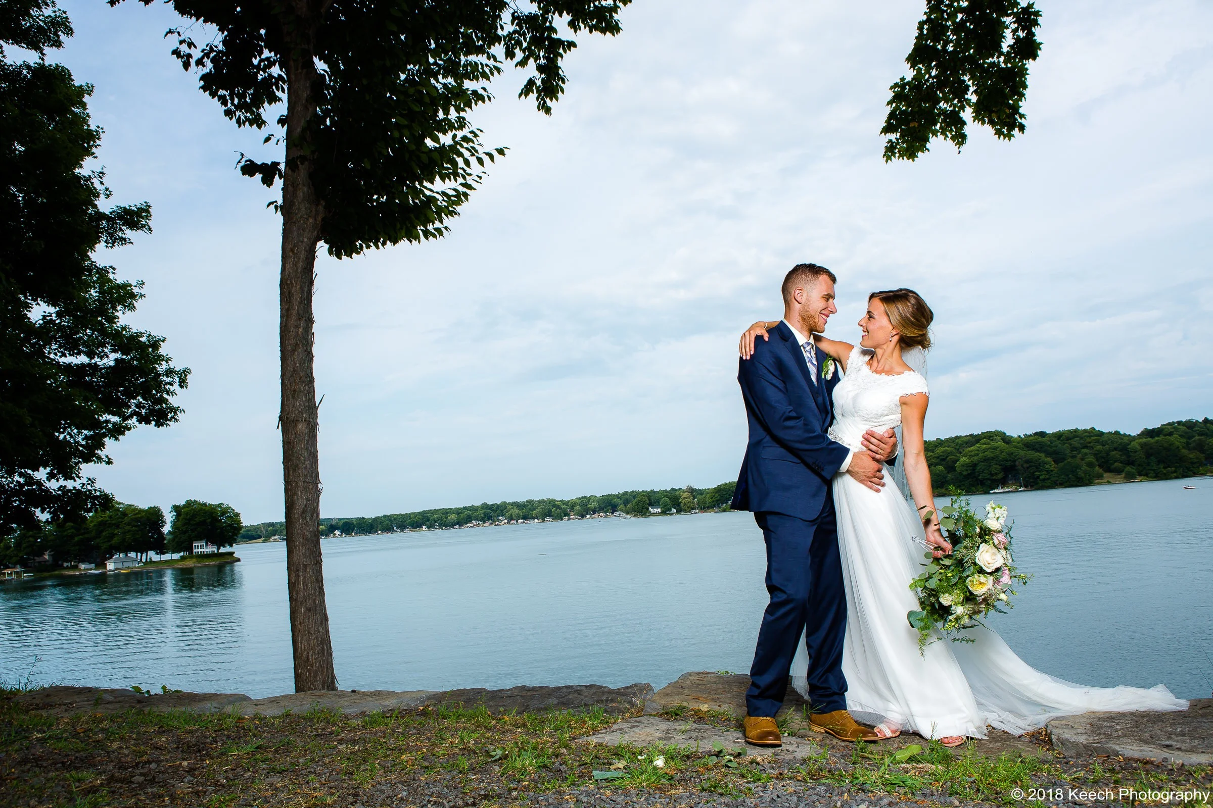Jillian and Jordan embrace in the backdrop of the million dollar waterfront views