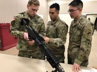 MSIV cadet showing two MSI cadets how to do a functions check on the M240B. Only one of these cadets had seen this weapon system before so it was fun for the MSIV to help him review what he already knew and for both of them to help teach their fello…