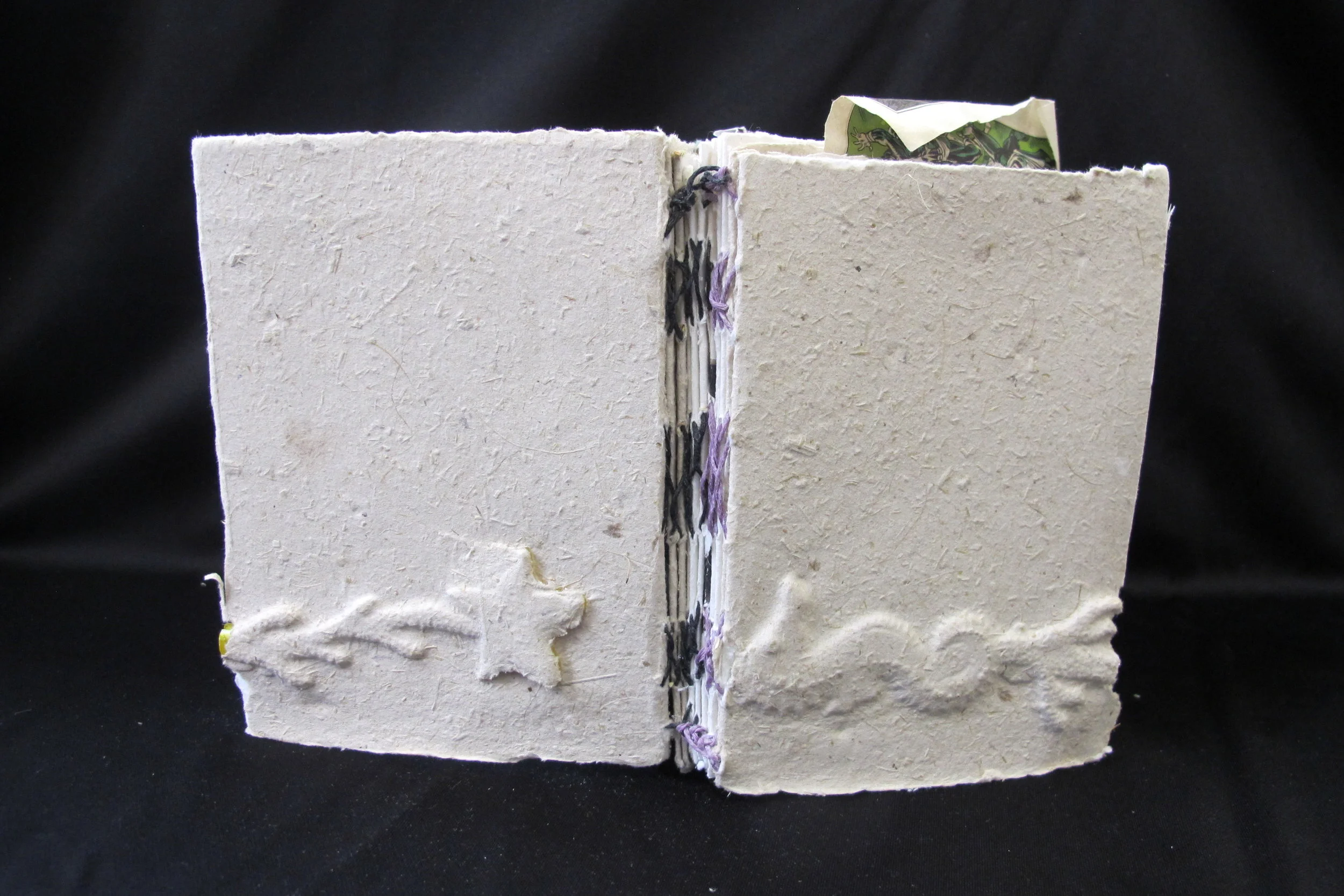   Untitled,  2015 recycled handmade paper, strings, comics, a cocktail stirrer  