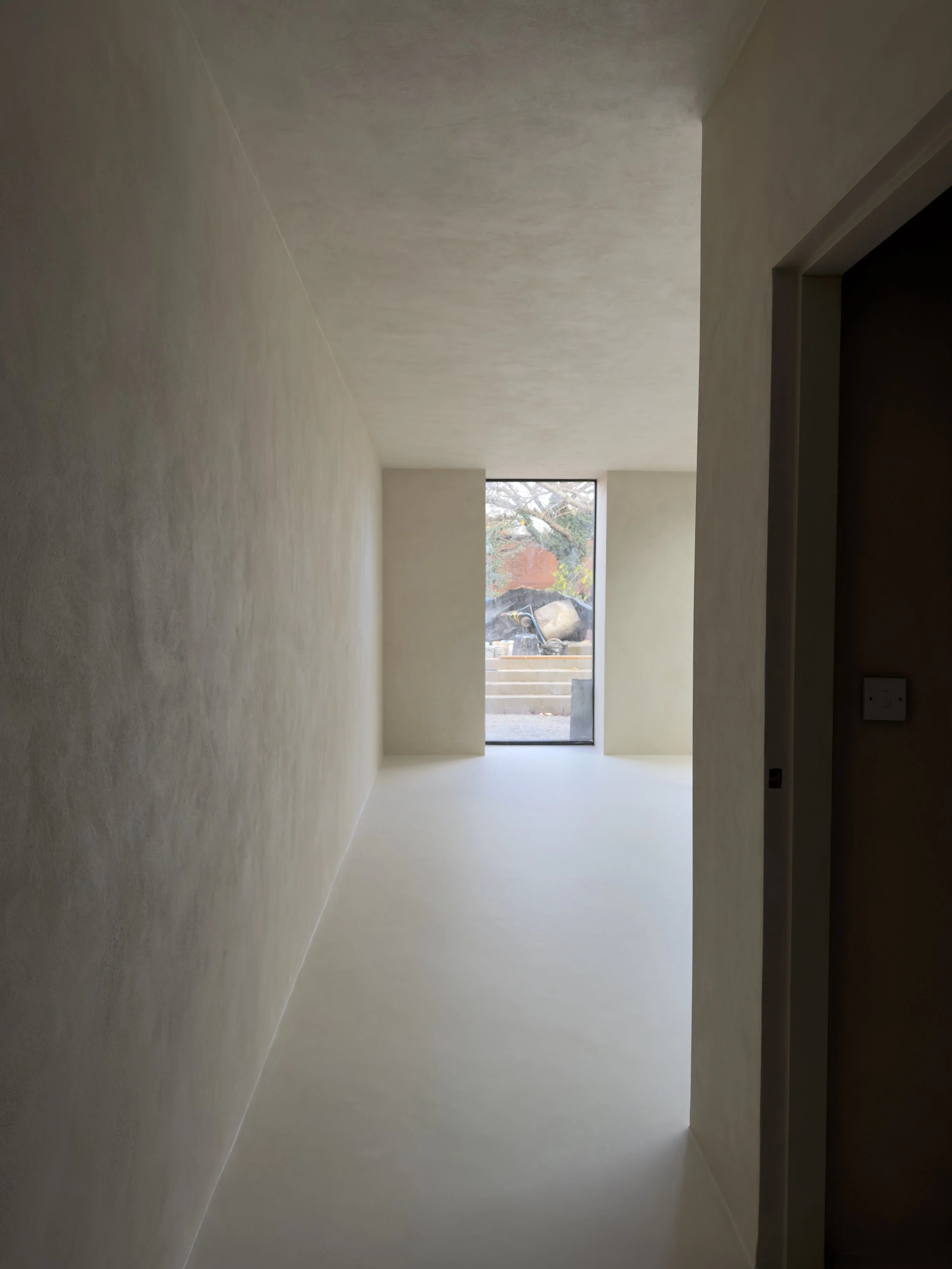 Seamless microcement floor and wall finishes within a contemporary residential interior