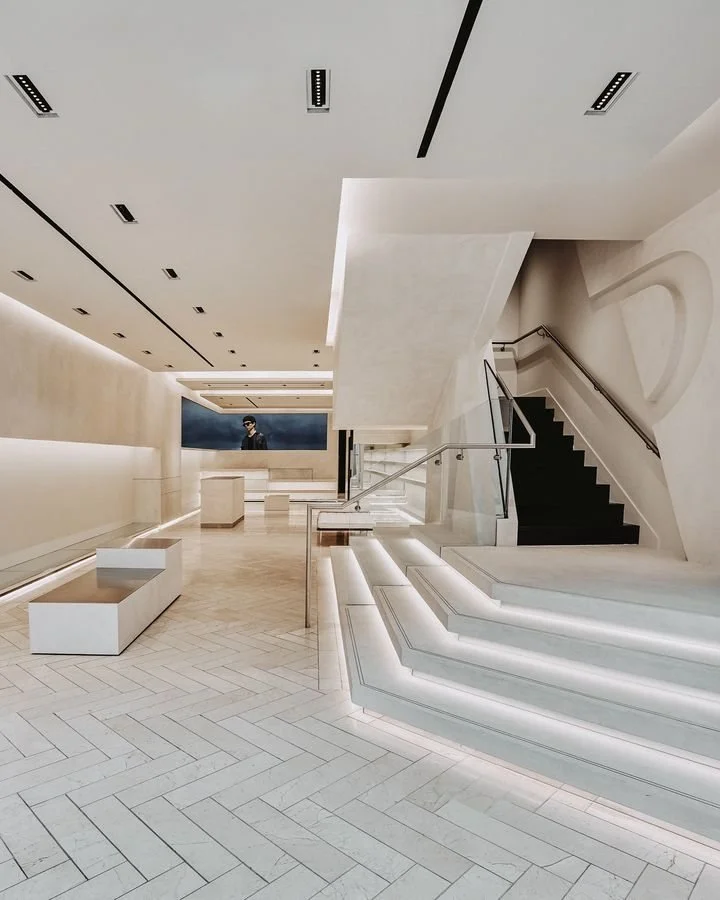 Microcement flooring, walls and staircase detailing at the Represent clothing store in Manchester