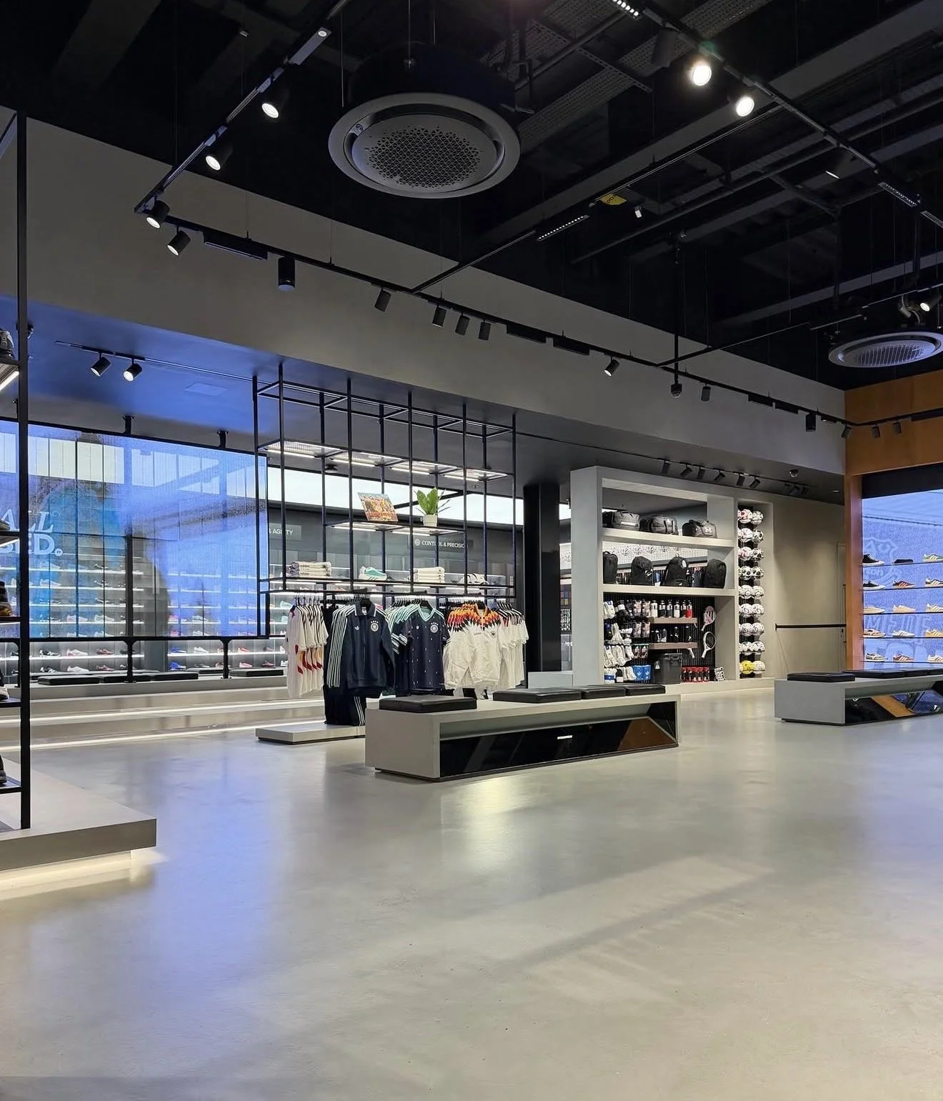 Athletic apparel and shoe store with polished microcement flooring.