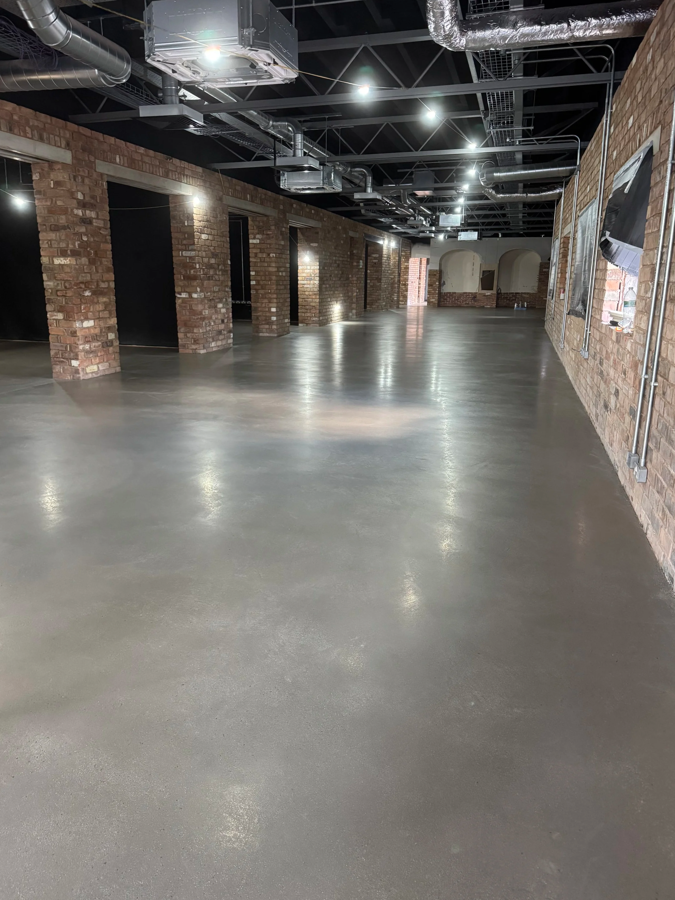 Polished microcement floor finish within a large commercial interior