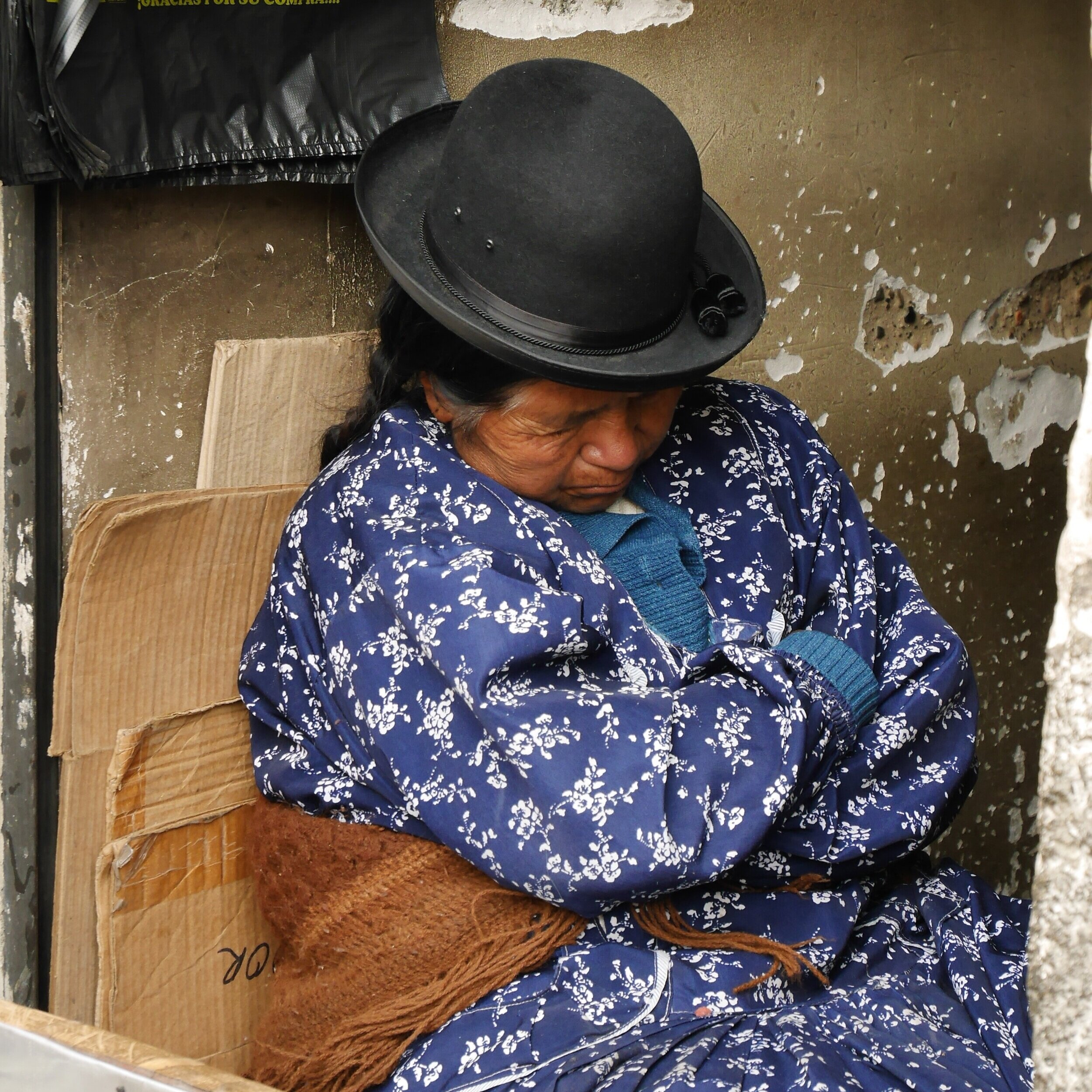 A hat seller having a midday nap in Peru