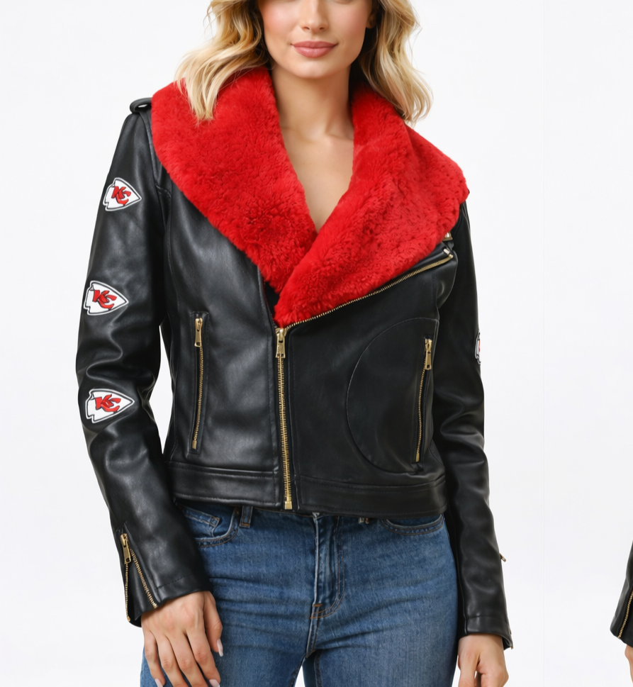 A woman wearing a black leather jacket with the Kansas City Chiefs logo patches and a red faux fur collar, paired with blue jeans.