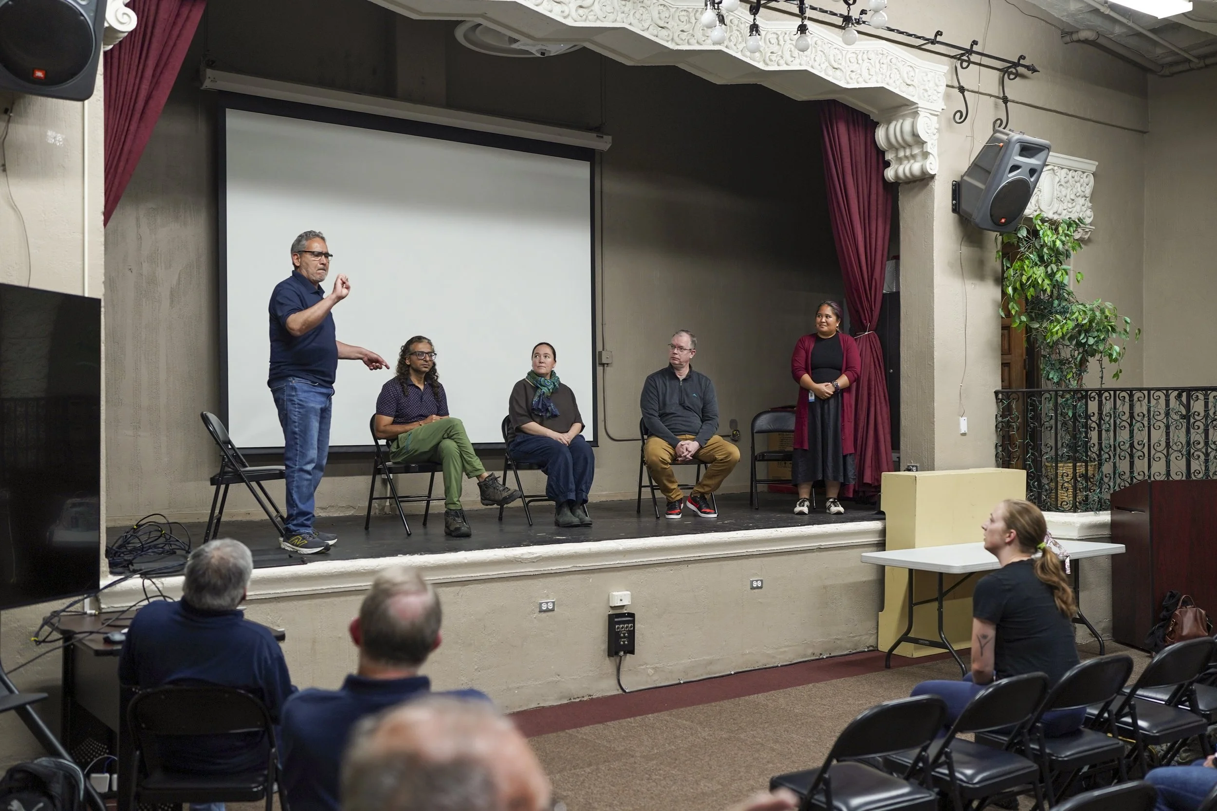 Panelists sit on a stage in front of an audience during a post-screening discussion of Being Michelle.