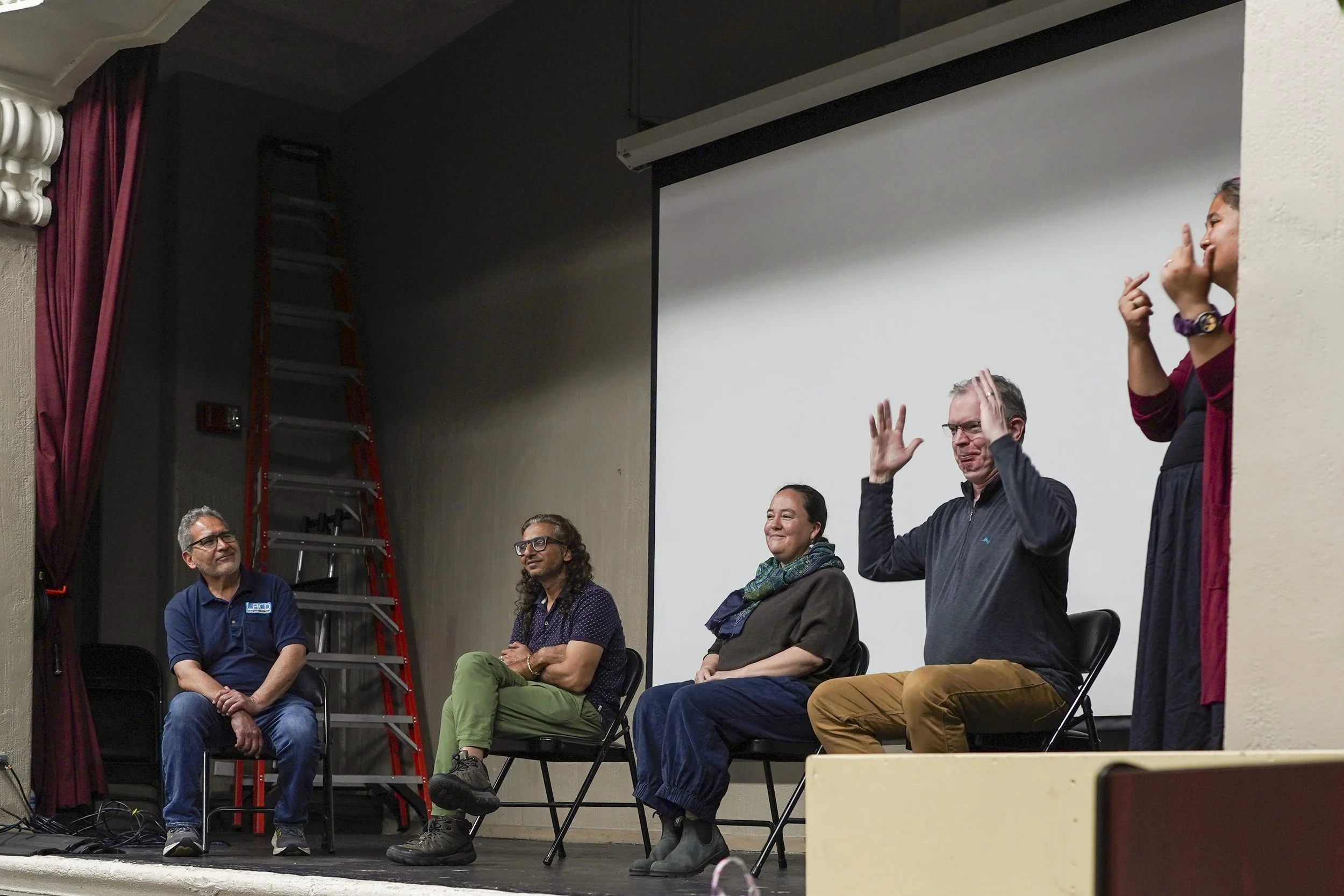 An audience member gestures while speaking during a post-screening discussion at a Being Michelle community event.