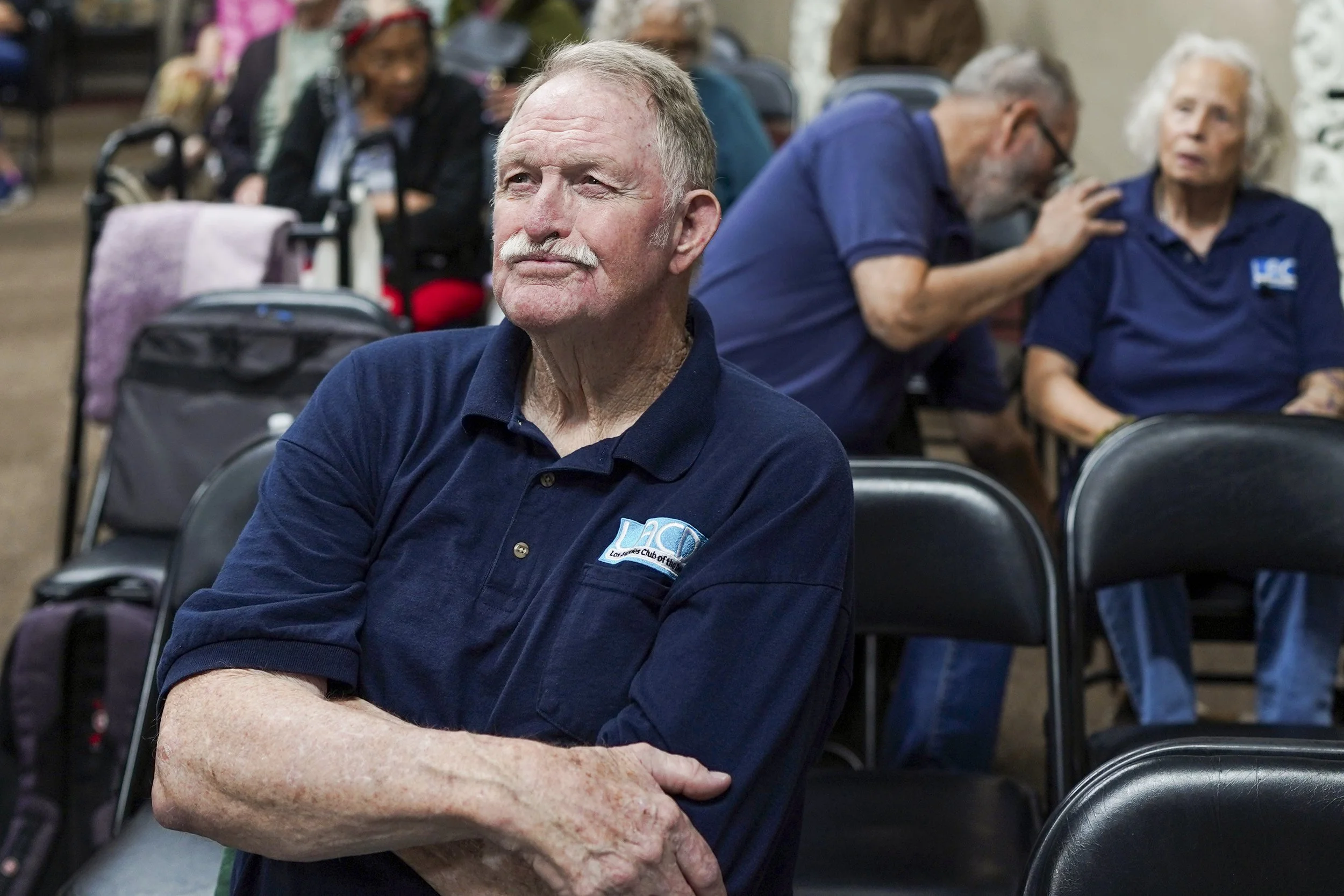An audience member sits thoughtfully during a community screening of Being Michelle, reflecting attention, engagement, and emotional presence during the event.