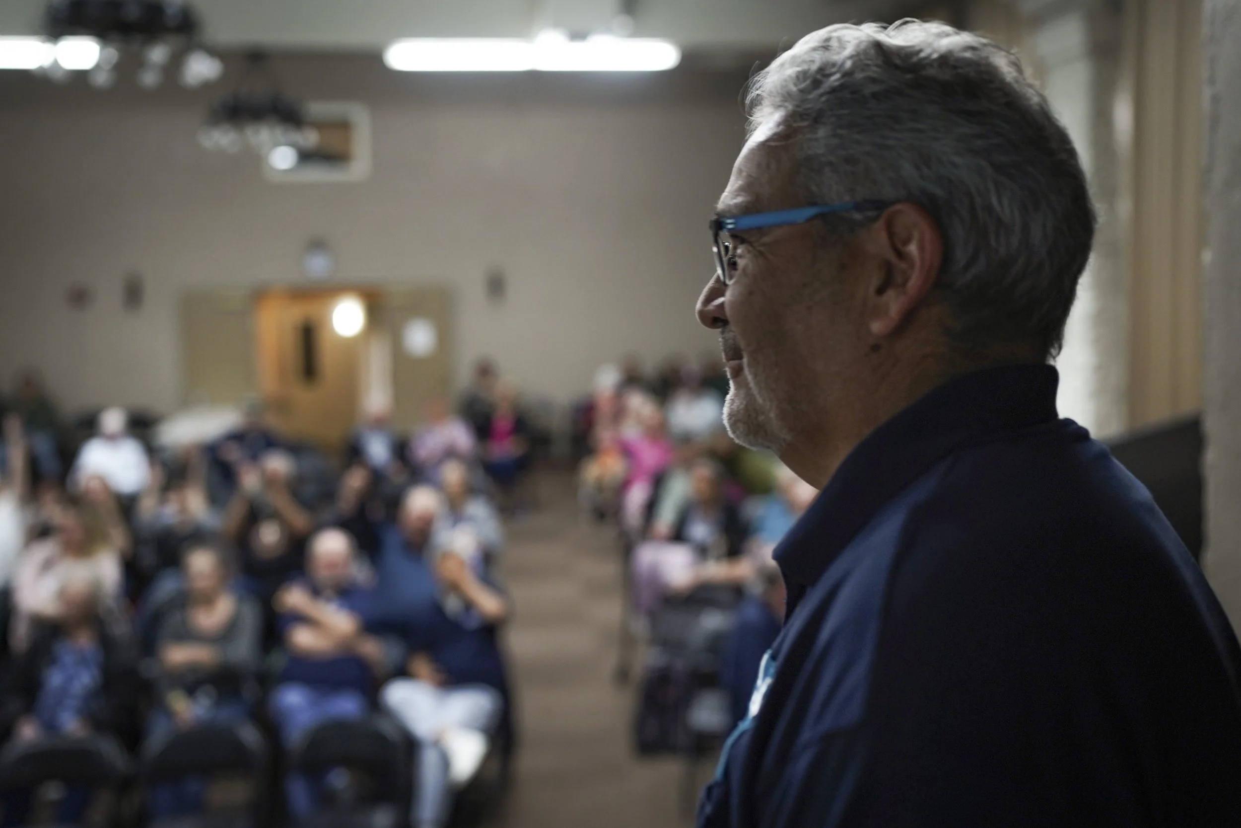 Audience members listen attentively during a post-screening discussion following a showing of Being Michelle.