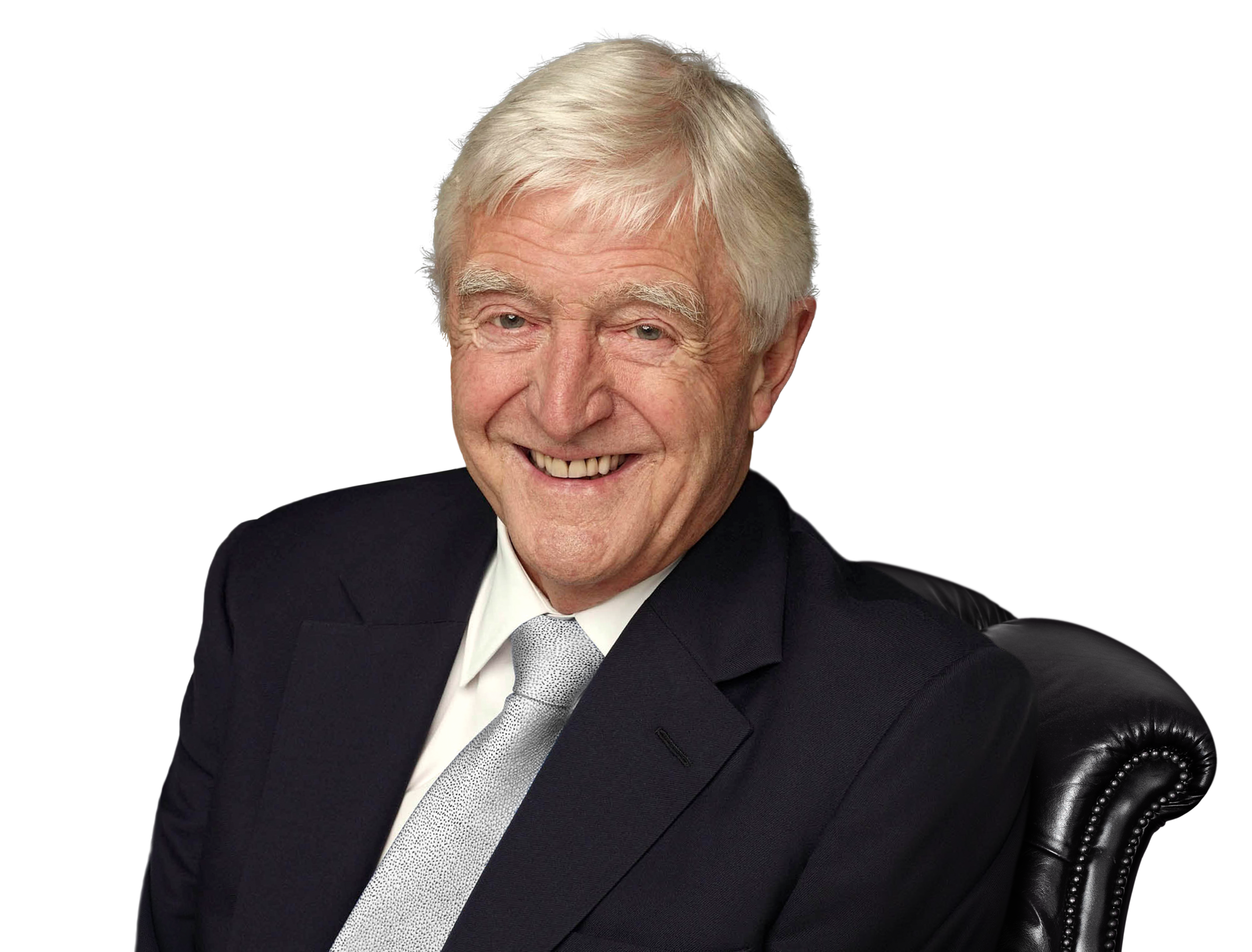 Sir Michael Parkinson sitting in a chair