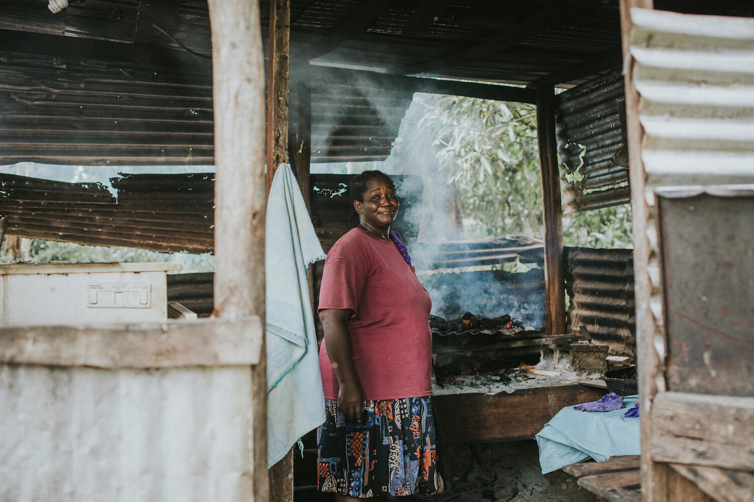 Local woman making bread from cassava that grows in the village.