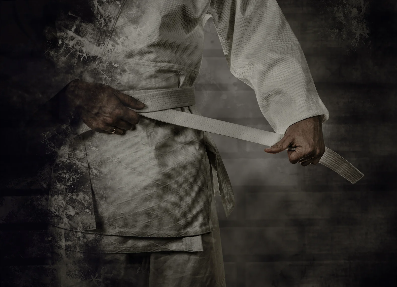 bigstock-Karateka-Tying-The-White-Belt--102490754.jpg
