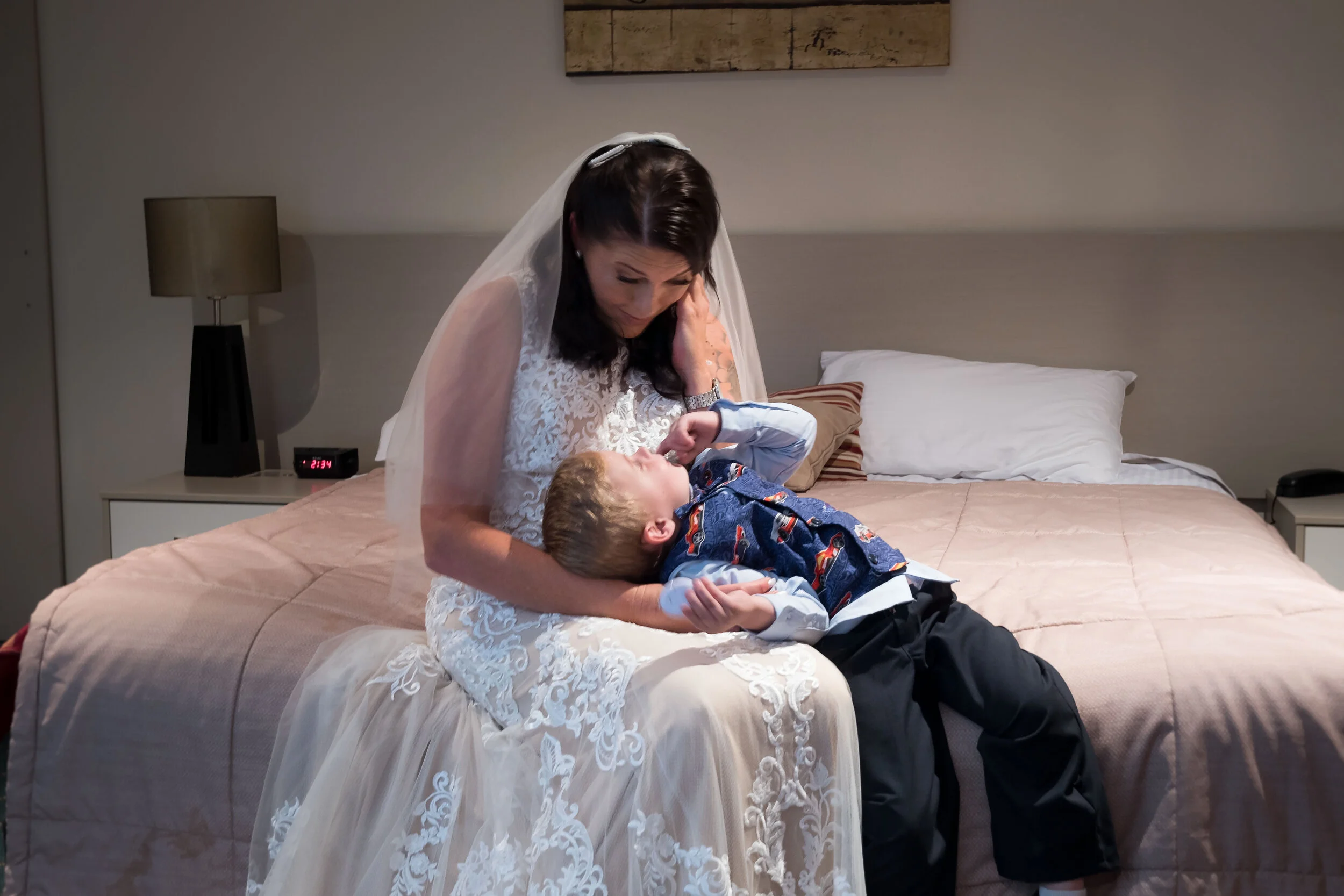 A bride sharing a tender moment with a young family member getting ready at Lloyds in Yatla, captured by Brisbane and Gold Coast wedding photographer Scott Hardy