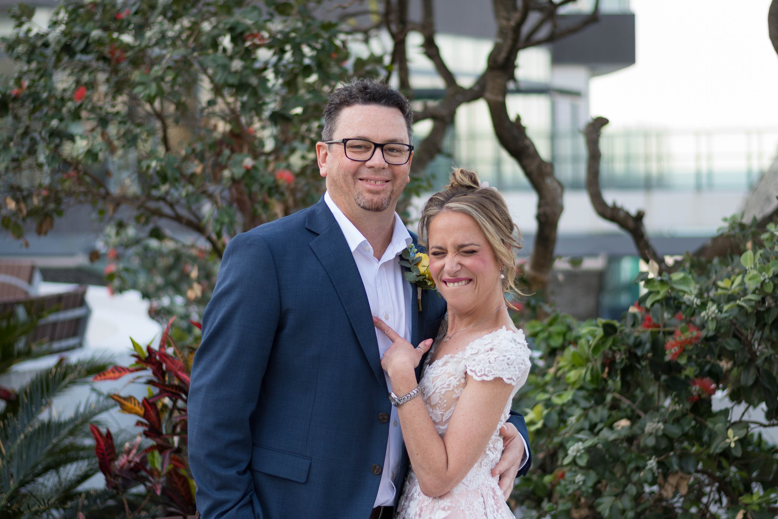 Happy couple smiling during an outdoor event photography session at a modern Gold Coast venue.