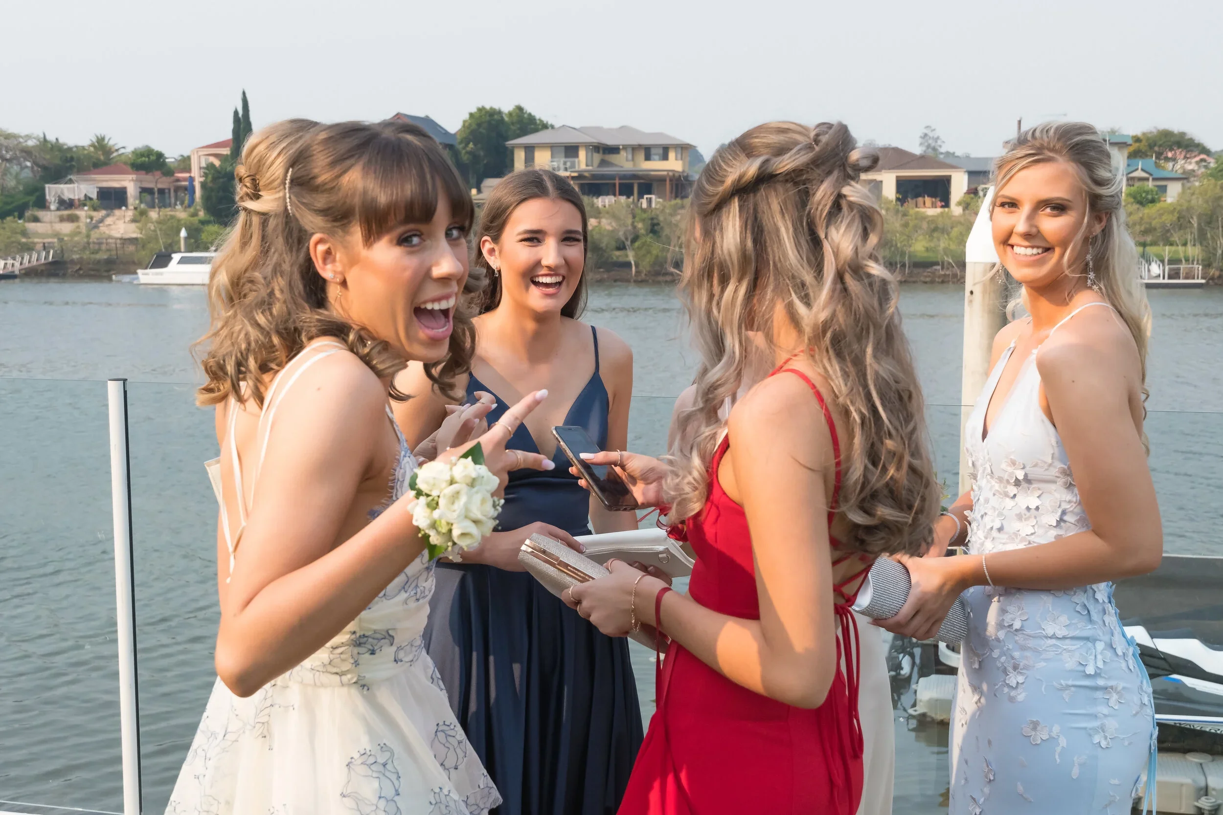 Students in formal attire gathering by the water for an All Saints pre-formal photography session on the Gold Coast, captured by Scott Hardy.