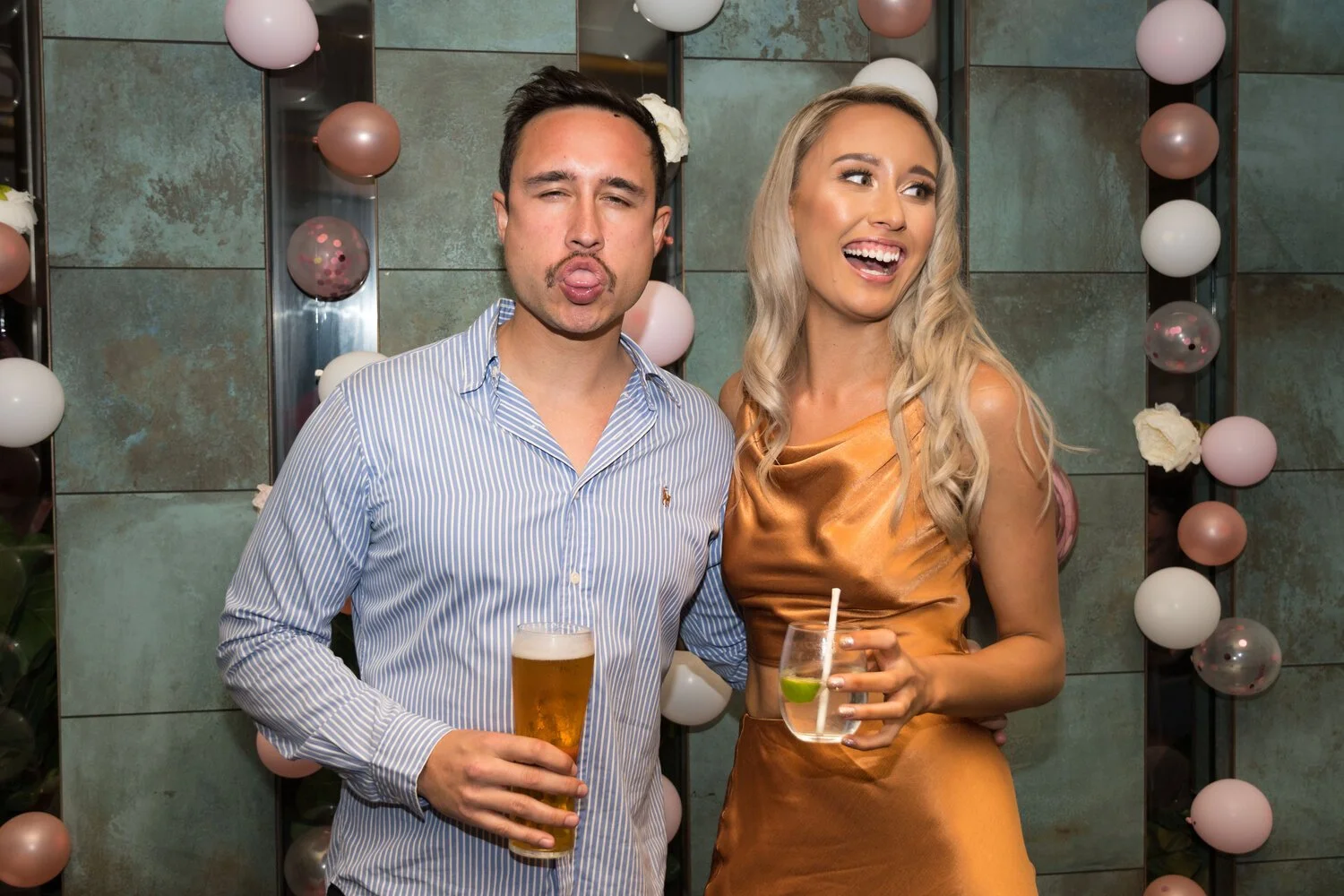 Guests celebrating a 21st birthday party with drinks and balloons at the Broadbeach Tavern on the Gold Coast, captured by event photographer Scott Hardy