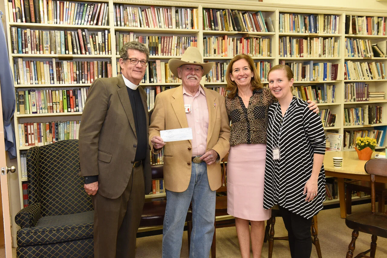 Culmore Clinic’s Rev. Andrew Merrow, Terry O’Hara Lavoie, Allison Colby receive a donation from the Lions Club of Bailey’s Crossroads.