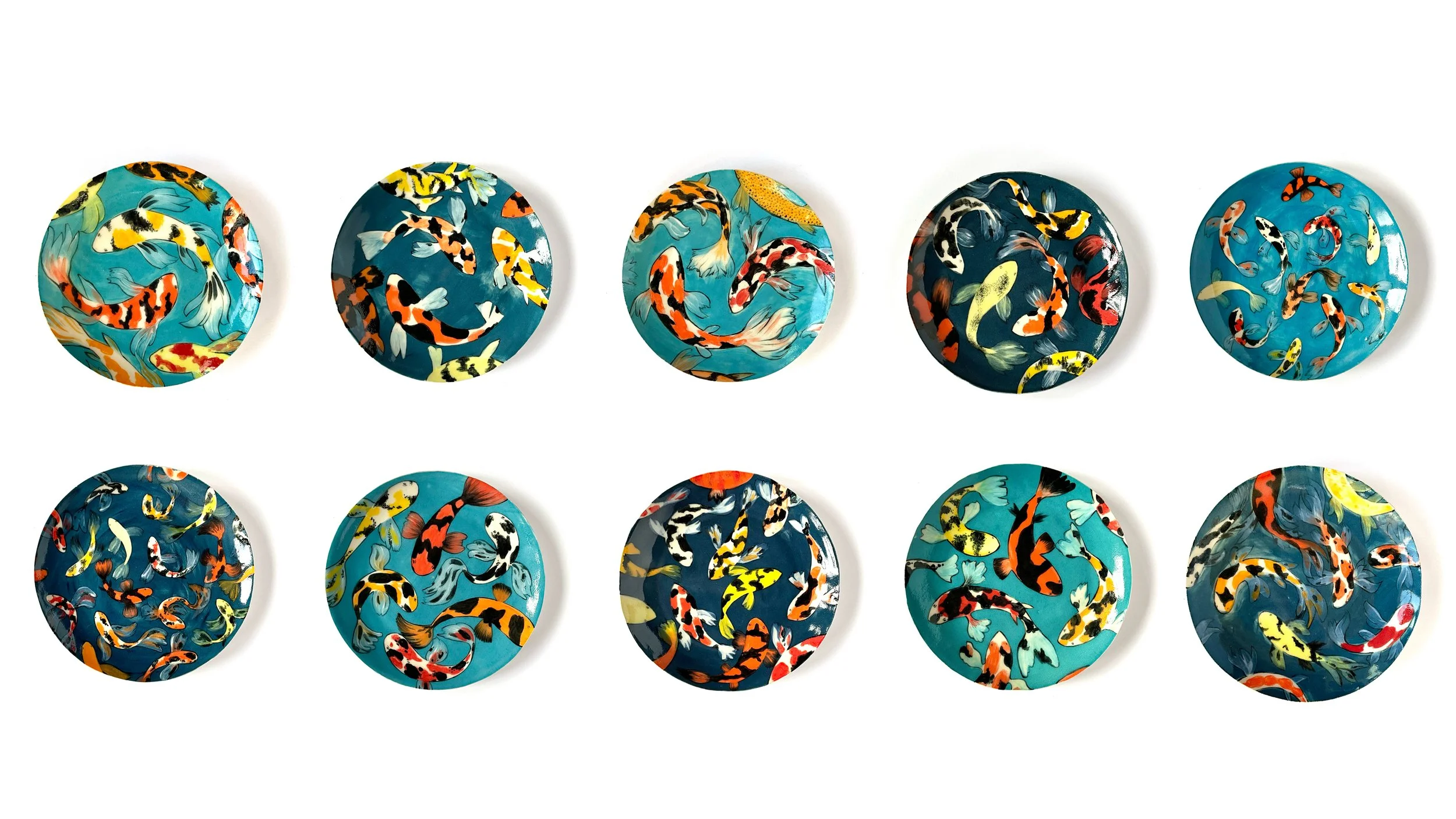 two rows and 5 colums (so a total of 10 plates) fill this image which has a plain white background. The plates are all circular and all have koi carp on them with different blue backgrounds.