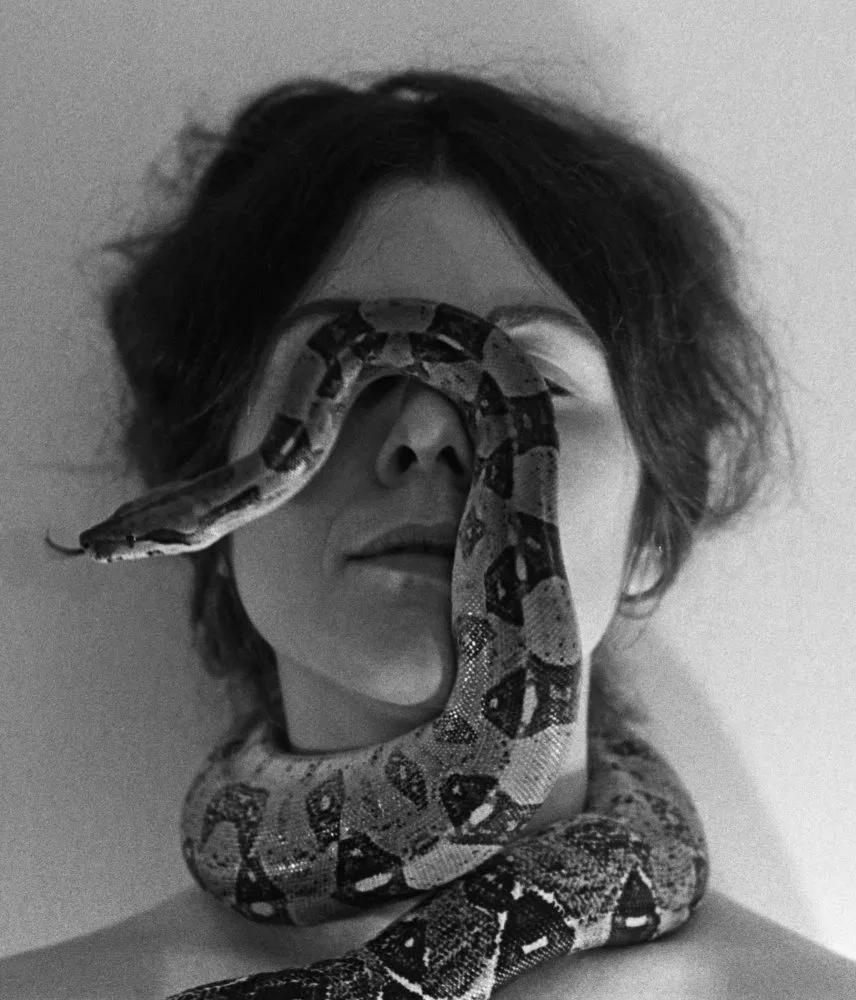Woman with snake on around her face. Confident. Self Portrait