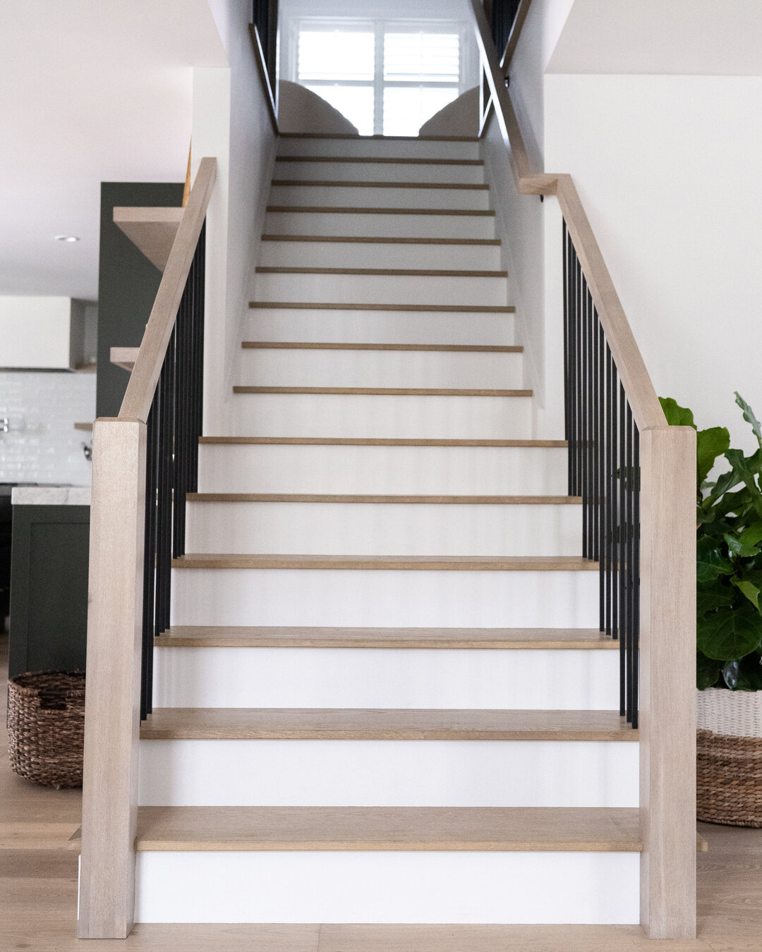 Out of all the special details of this remodel, the staircase truly takes the cake! We love the transformation from the builder-grade carpet to the custom painted white risers and European oak treads! By replacing the second story pony wall with the 