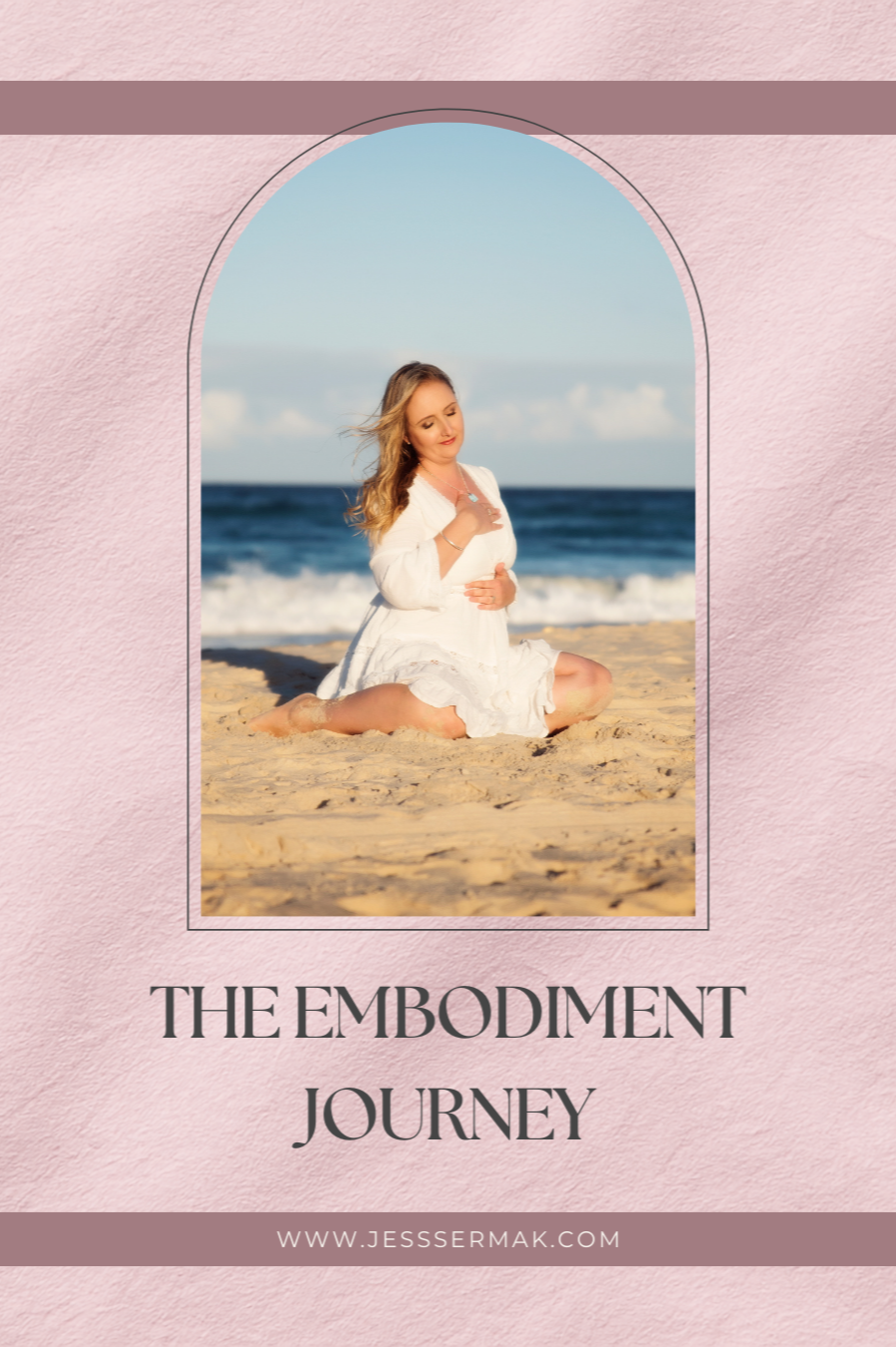 Woman kneeling on a sandy beach near the ocean, wearing a white dress, with her eyes closed and hand on her chest, background of blue sky and ocean waves.