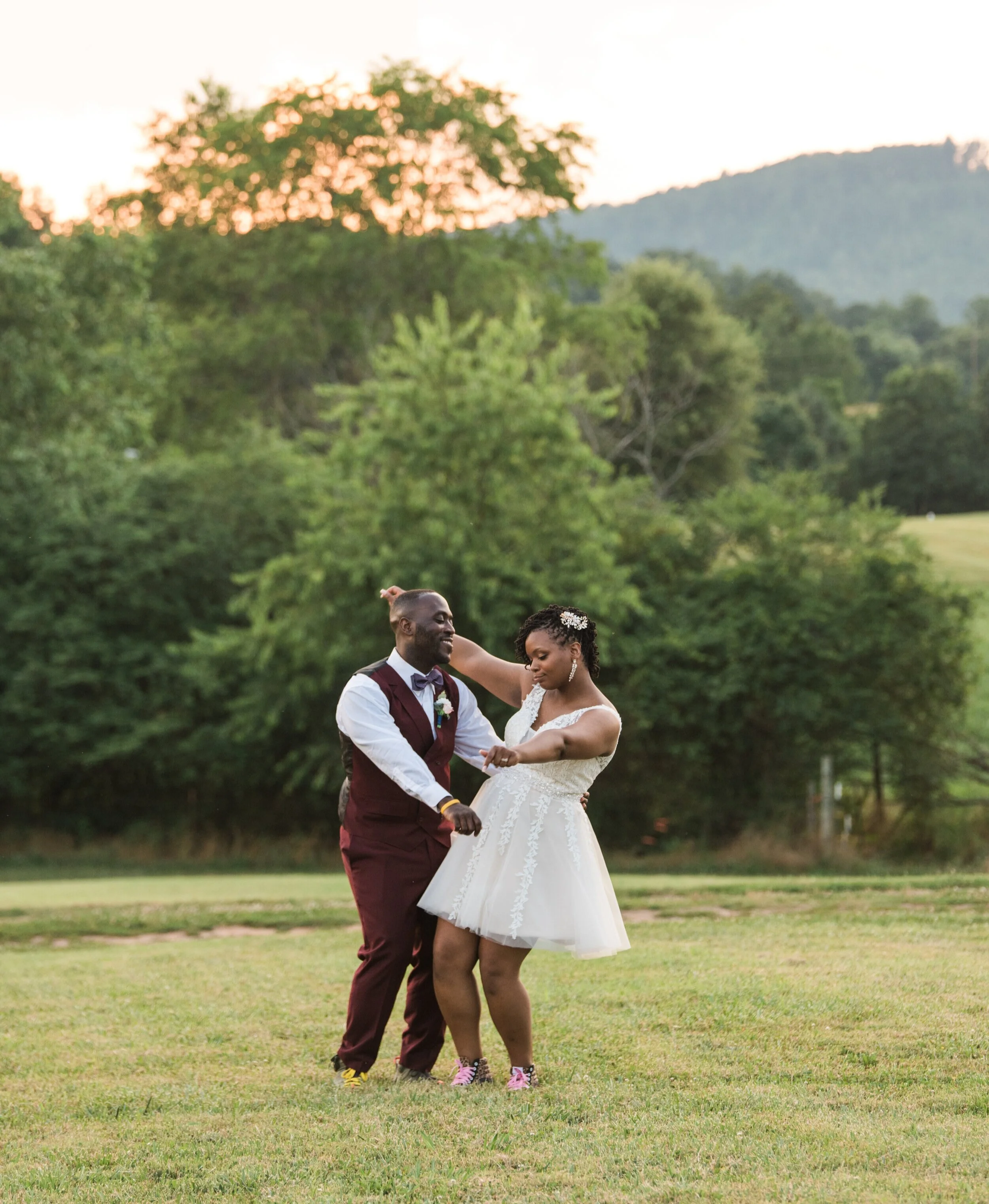 A coupld dance as the sun sets behind them at the Barn at Cranberry Creek