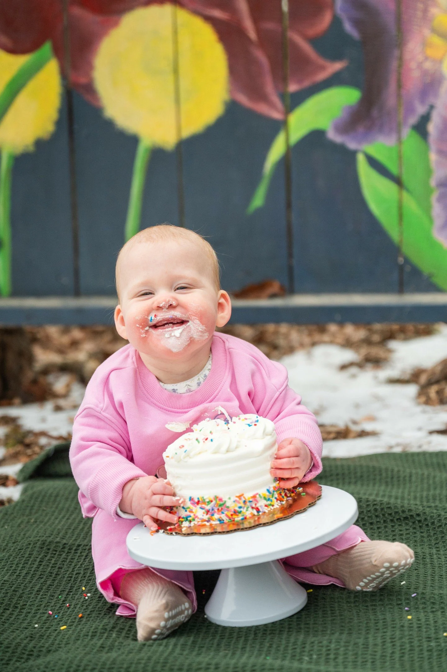 I mean, c'mon...have you ever seen a cuter little grin?!? After three weekends of snow and ice and reschedules galore, I finally got to photograph this sweet family and their twin girls' first birthday cake smash!  Yes, there was still snow on the gr