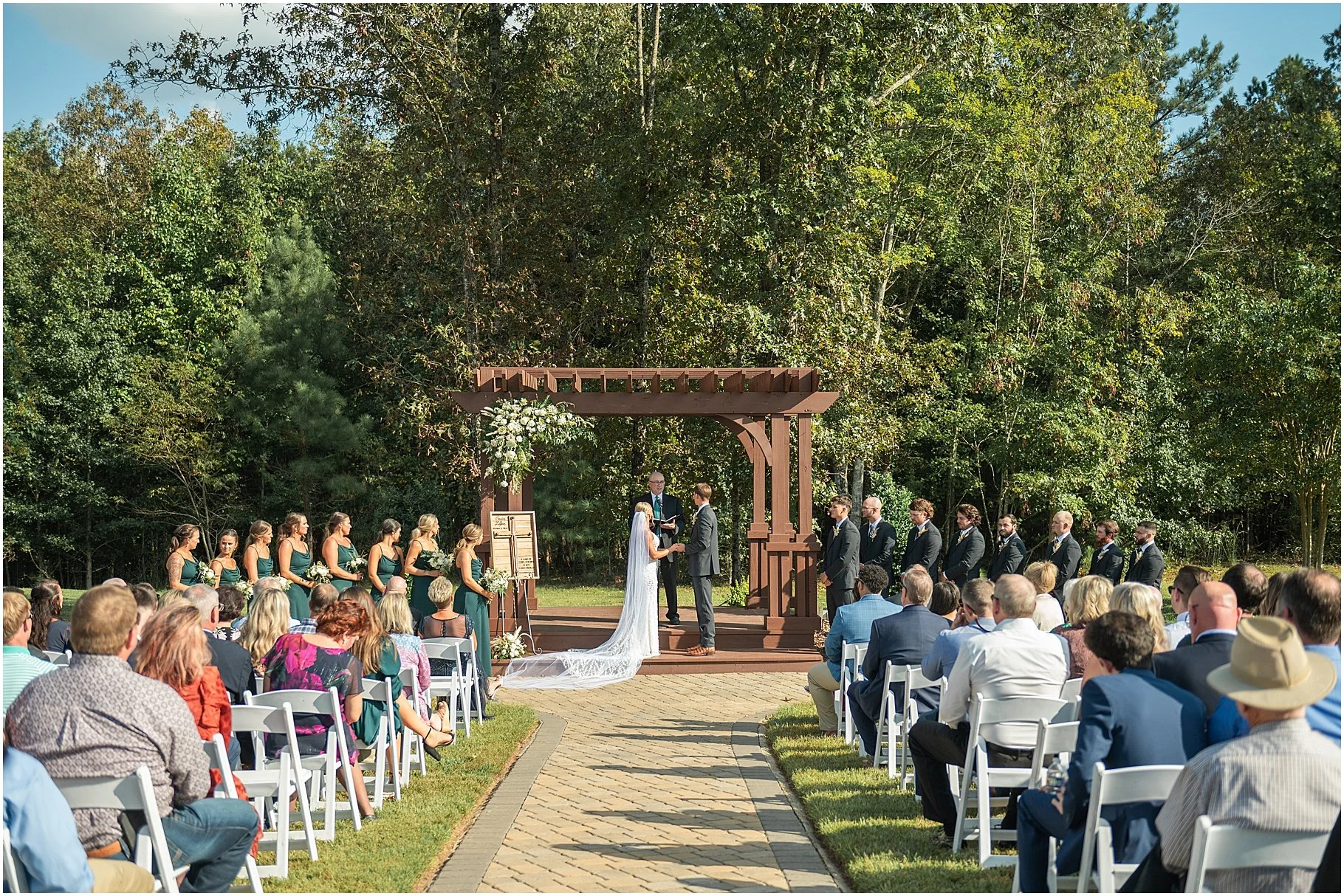 Bride and Groom standing at the altar during their wedding ceremony at Cedar Creek Ranch in Waxhaw, NC