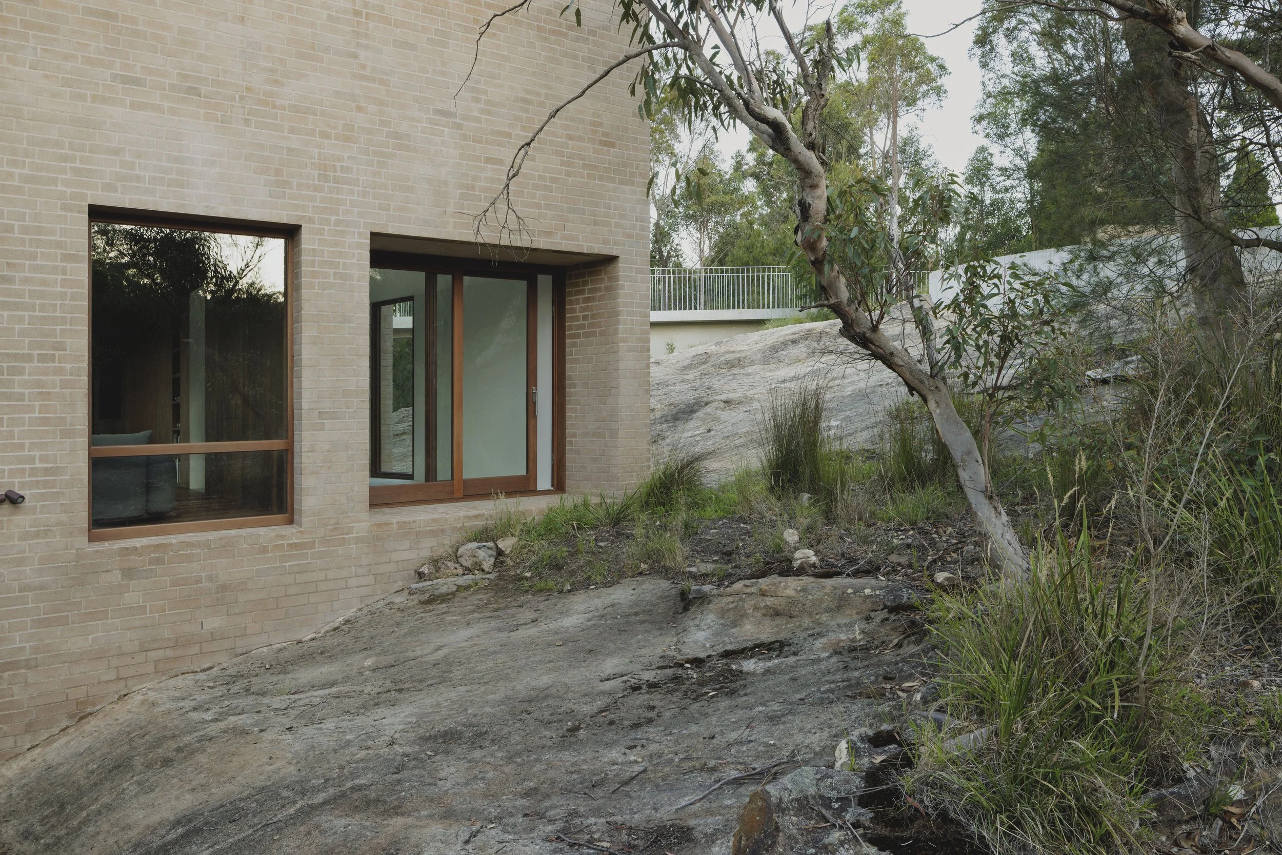 Architectural home on a rock cliff face. House integrated into its landscape.