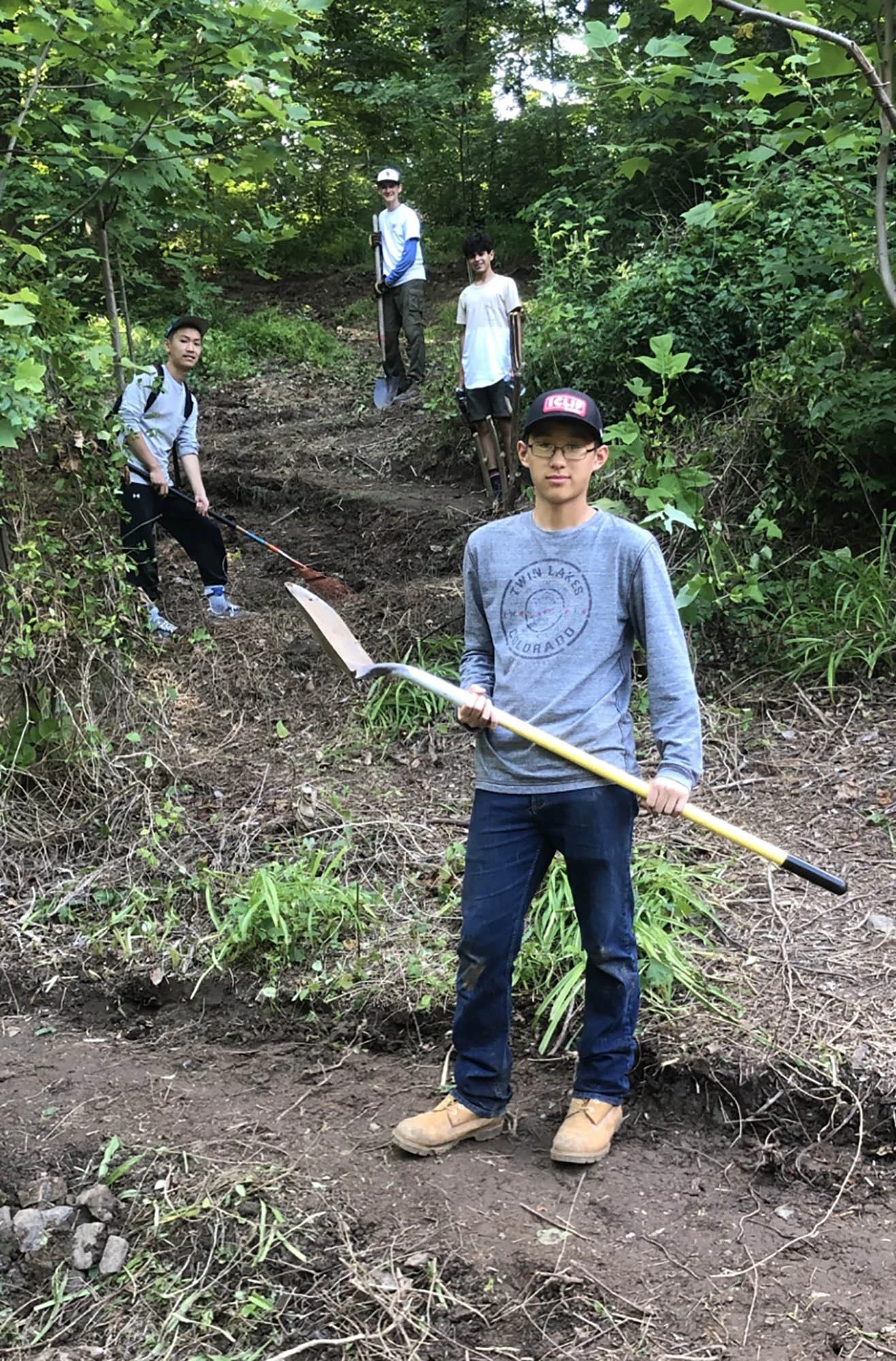 Gabriel Ma (front) worked recently on a switchback trail with friend Andrew Huang (left) and fellow Boy Scouts including Jack Henry (left at top) and Jack Santee (right at top.) Photo by Lee Hoffman.