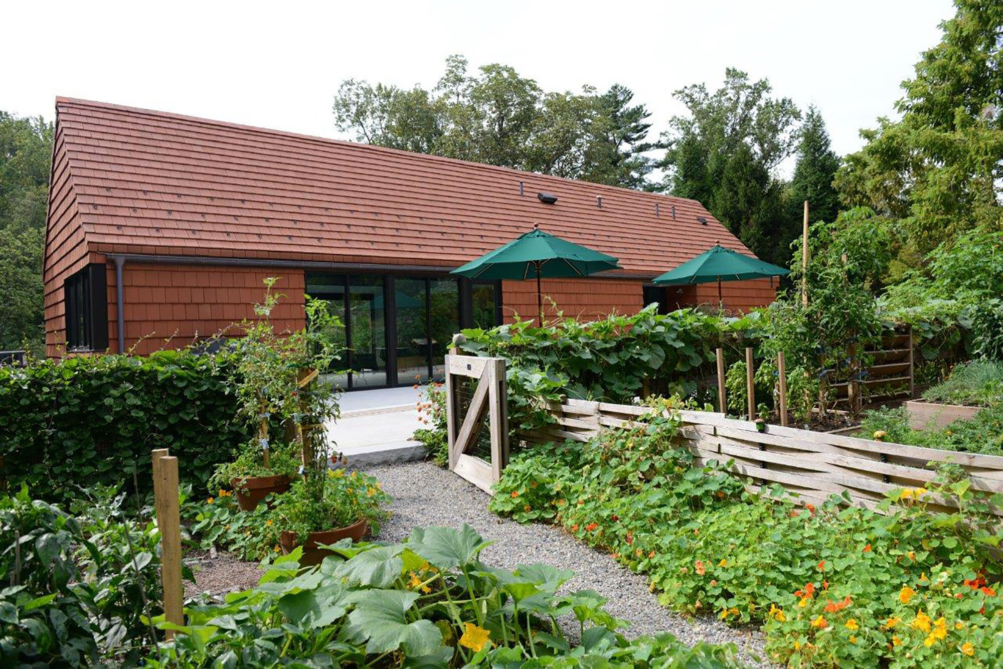 The terra-cotta tiled Schoolhouse — with a demonstration kitchen at the head of the classroom — adjoins Tyler’s Edible Garden. Photo by Tracy Clark.