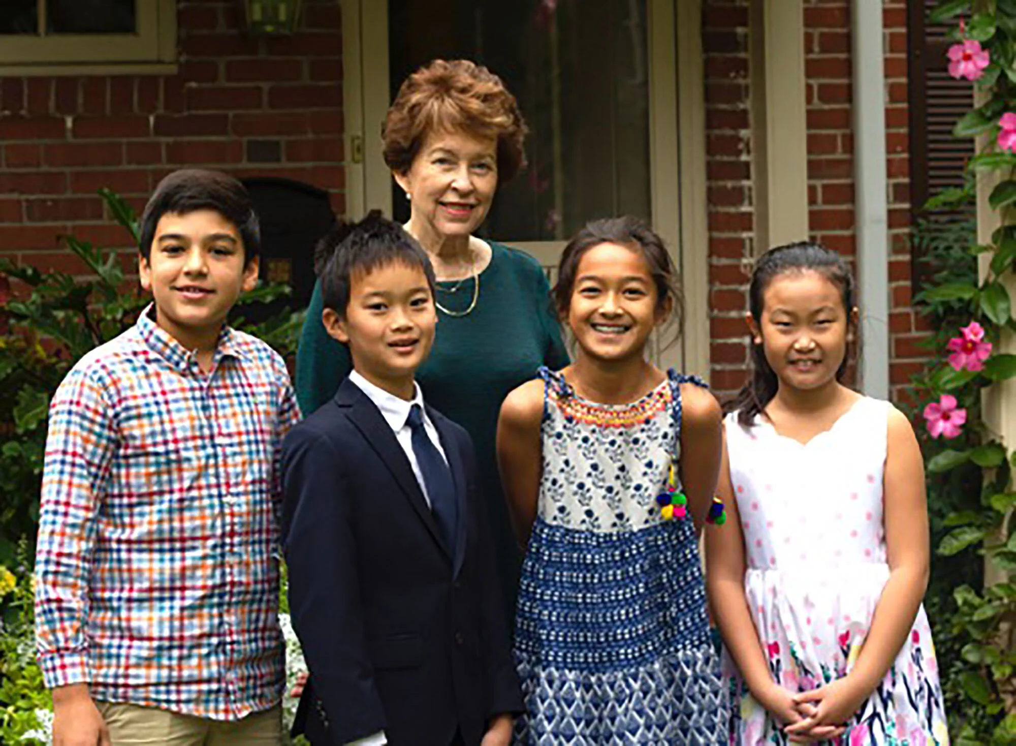 Piano teacher Donna Kay Jones stands behind her students (left to right) Ted Clark, Vincent Zhu, Daksha Nair, and Shannon Yue.