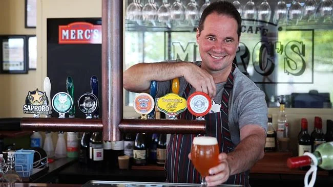 Paul at Merc's serving beer.jpg