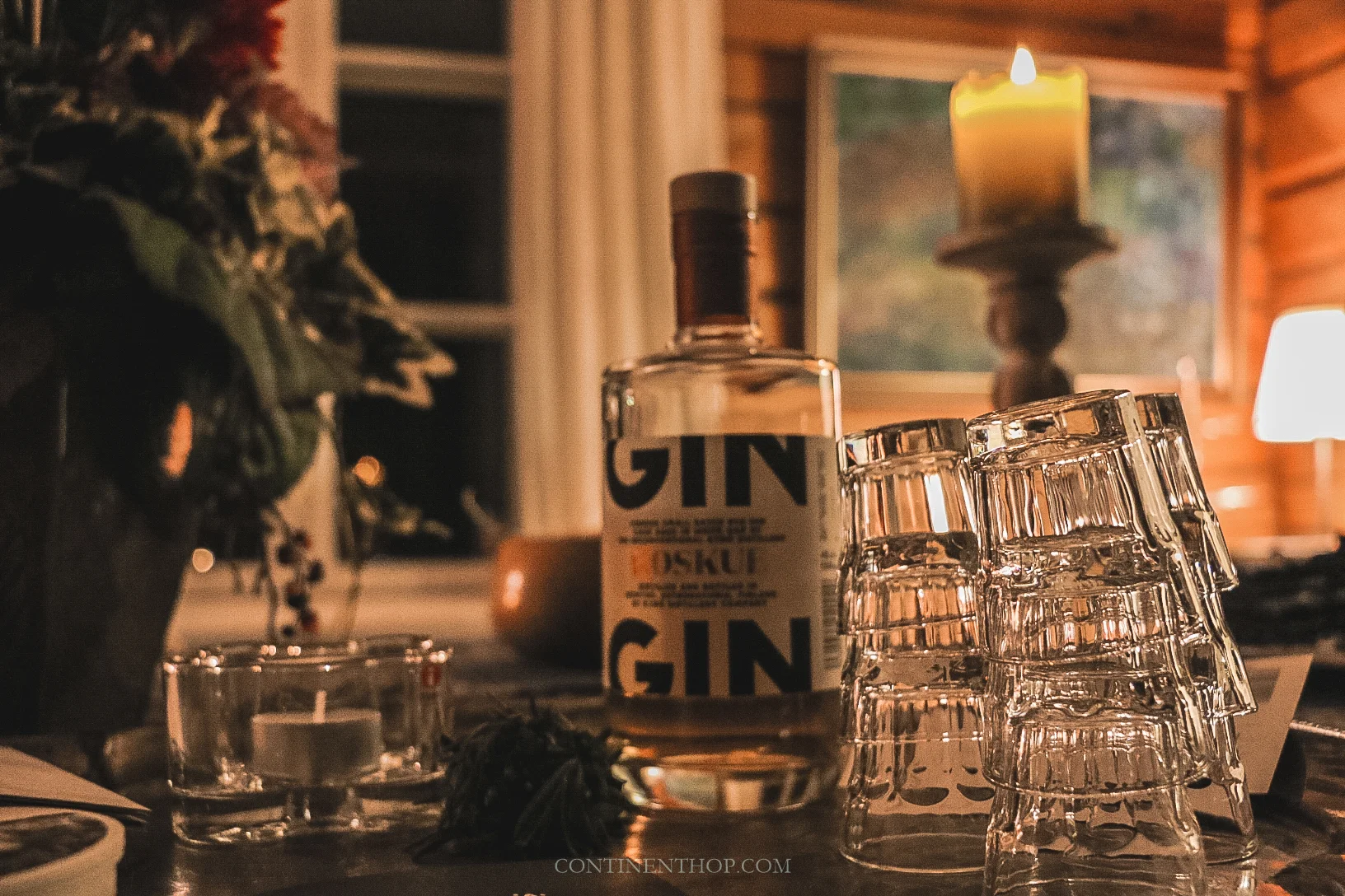 typical finnish food with gin, glasses on the table and centrepieces