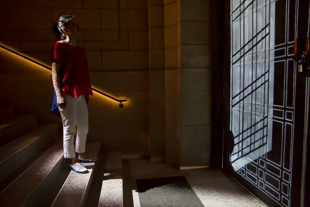 Moving through the revolving doors and onto the stairs triggered a projection of pouring minuscule, molecular forms, similar to sand on the floor. This video mapping also included a projection on the brass doors of the former entry, which repeated and emulated the doors’ design in various iterations and was further programmed to create an optical illusion of the doors alternately opening and closing.