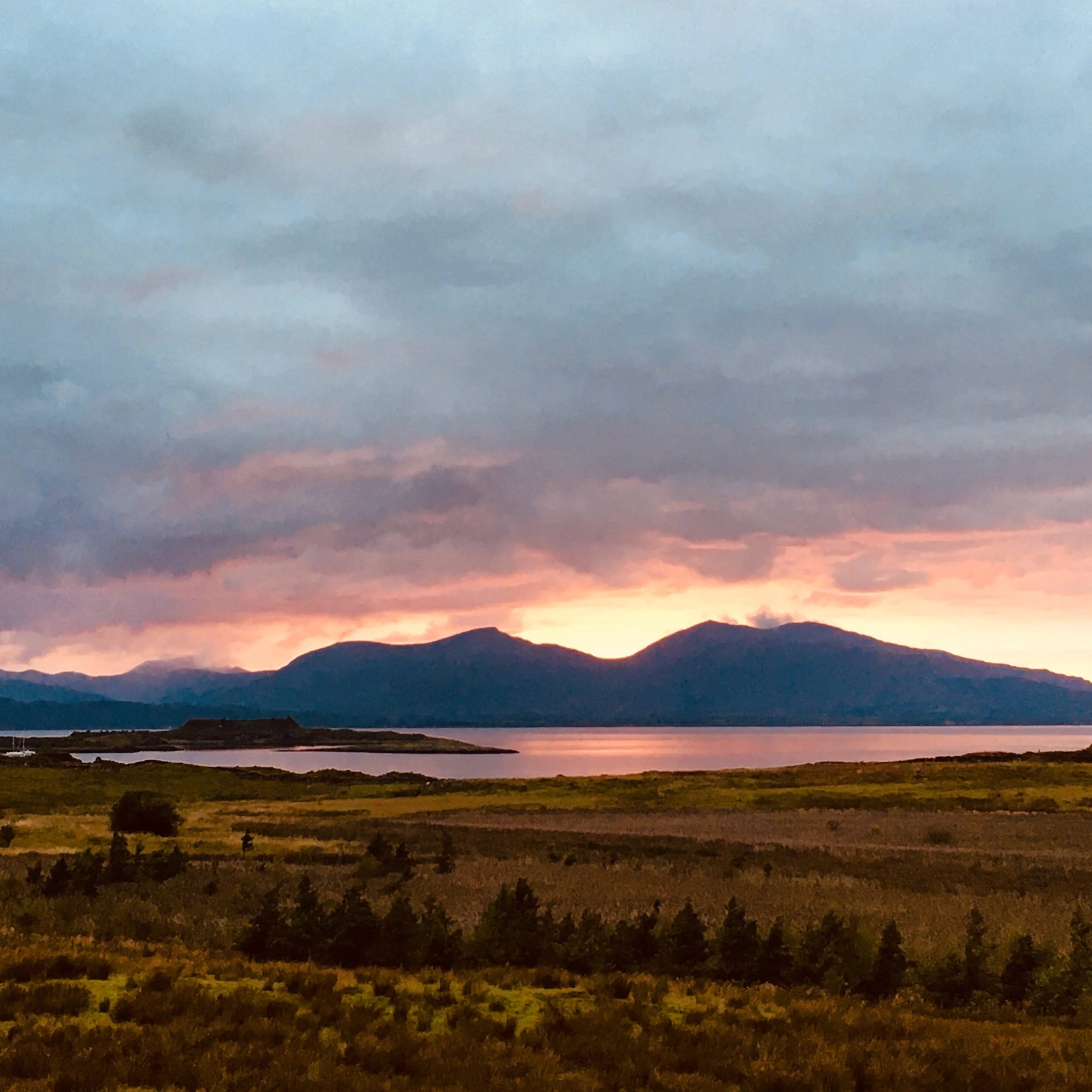 Sunset framed by the blue hue of Mull from Kerrera