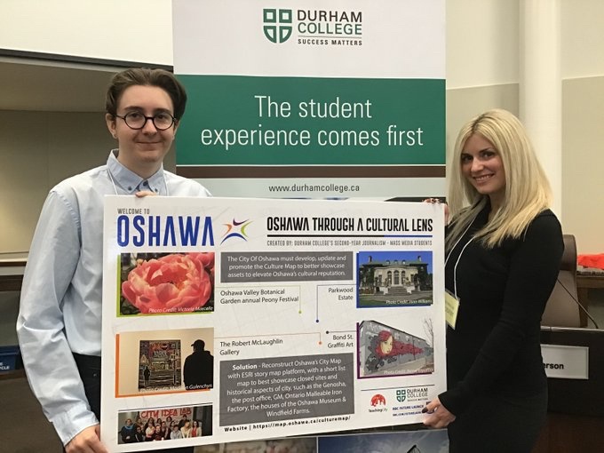 2 Durham College students presenting a poster