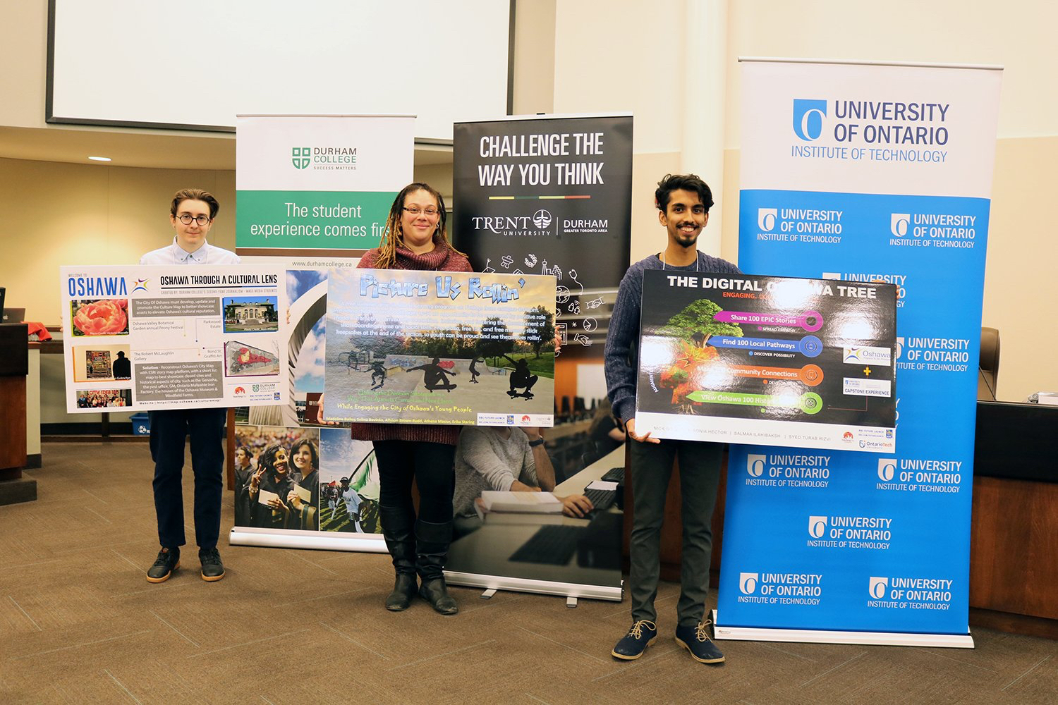 3 Students holding their posters