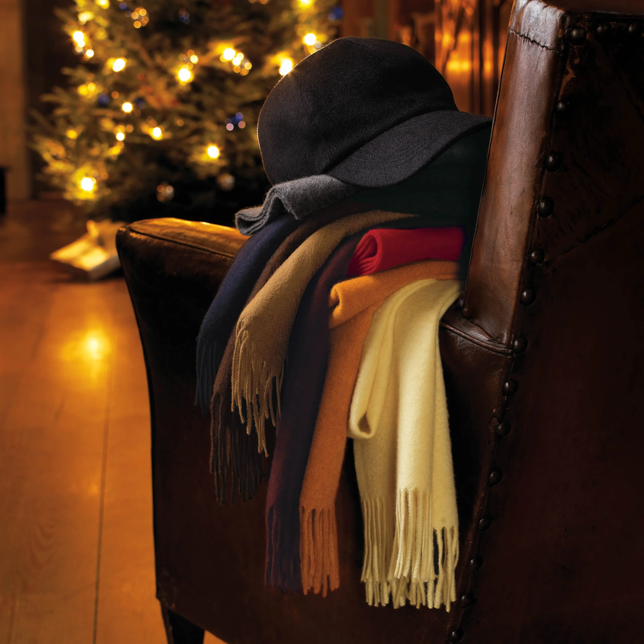 Armchair stack of scarves and hat.jpg