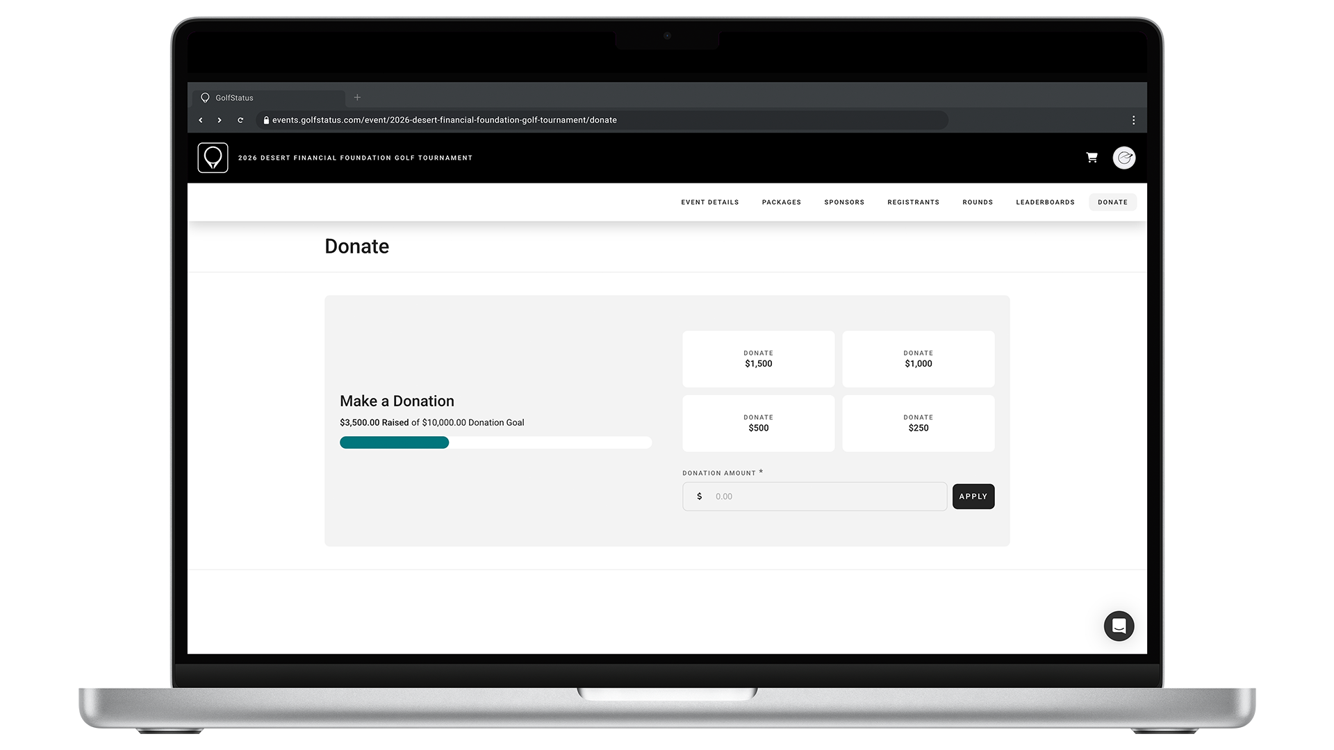 A golf tournament website showing a donation tracking bar is displayed on a laptop computer.