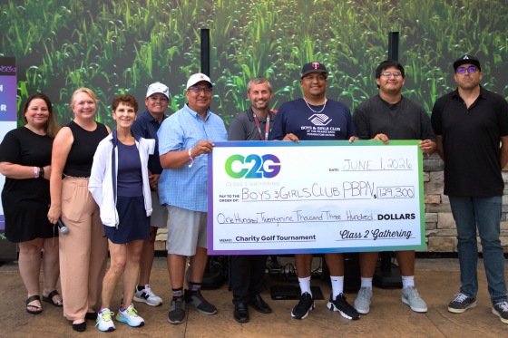 A group of eight people holding a large check awarding $120,000 to the Boys and Girls Club of the Potawatomi Nation from the Class 2 Gathering Golf Tournament.