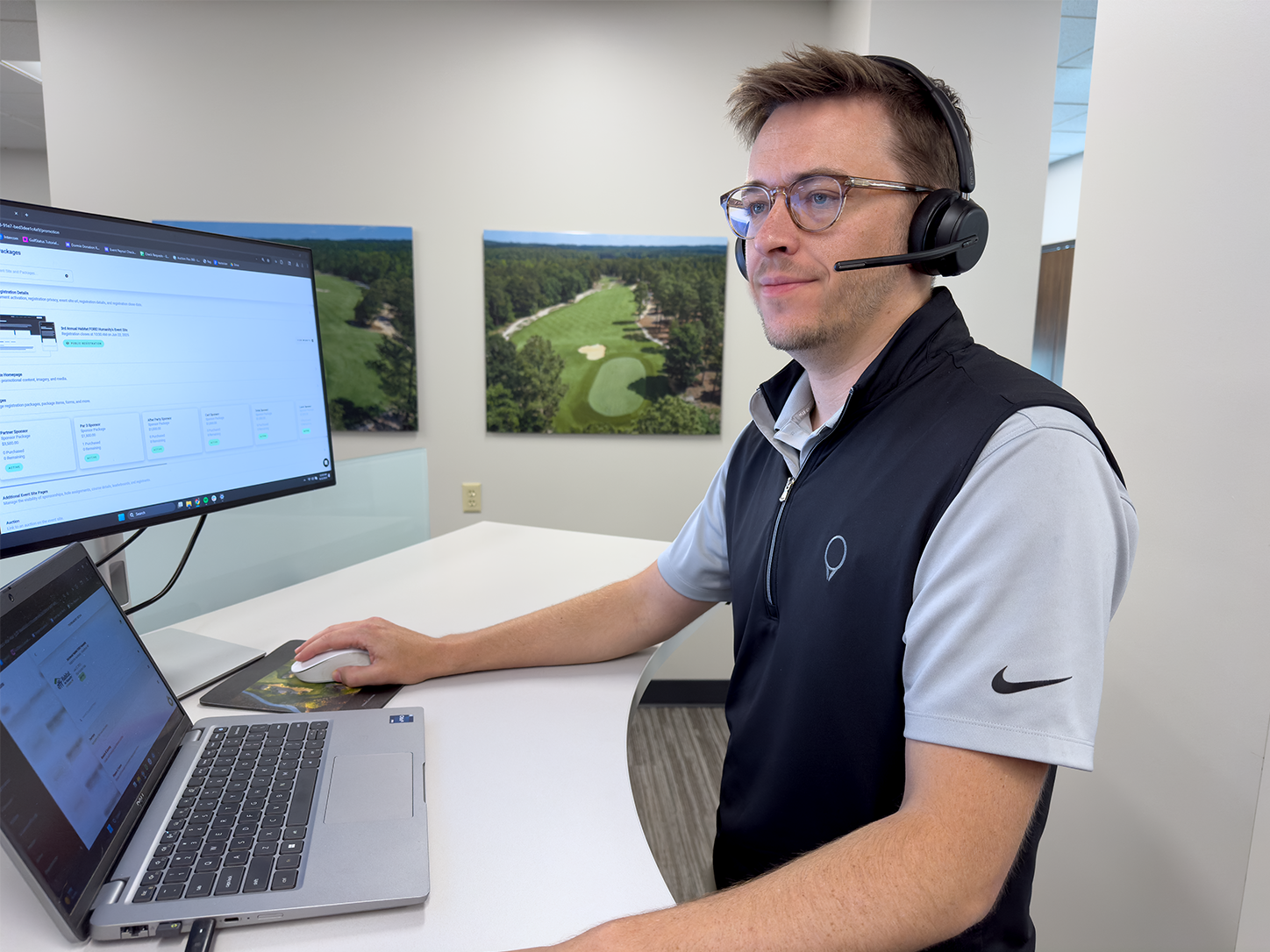 A photo of one of GolfStatus' Golf Tournament Fundraising Specialists looking at a computer screen.