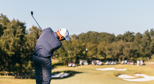 A man hits a tee shot a charity golf tournament.