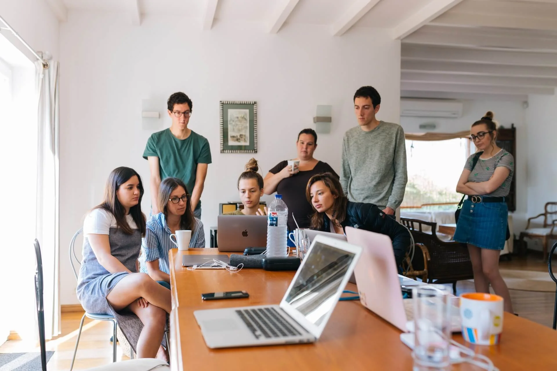 A golf tournament planning committee looks at a computer.