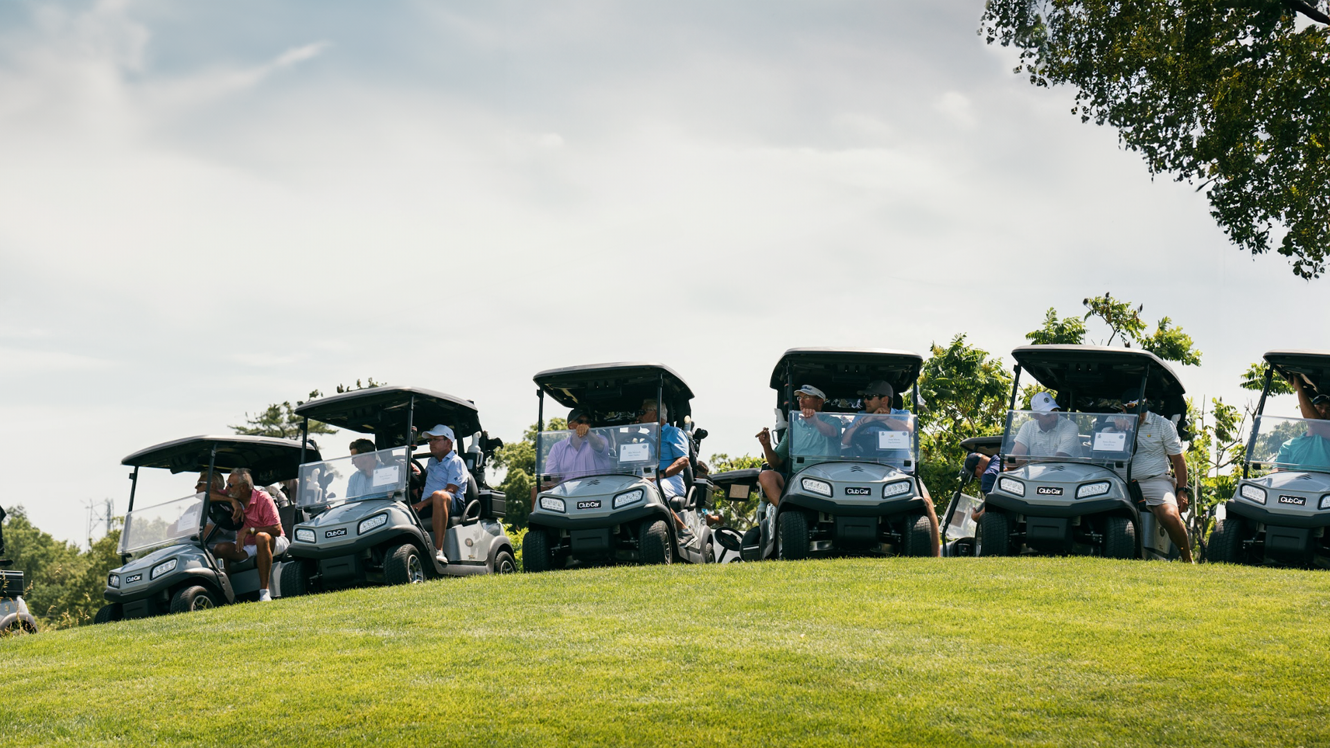 Golf carts are lined up at a longstanding golf tournament.