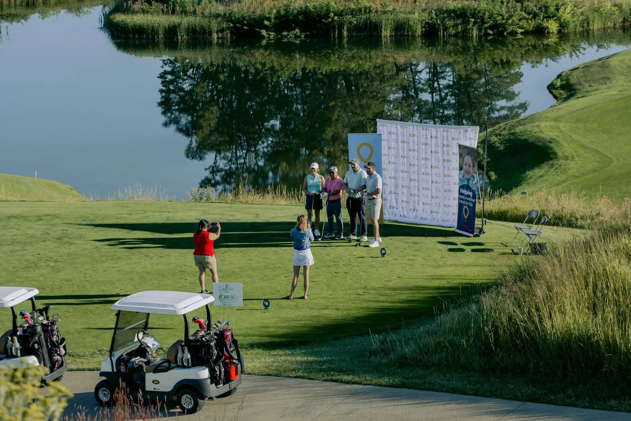 Golfers pose for a photo at a charity golf tournament.