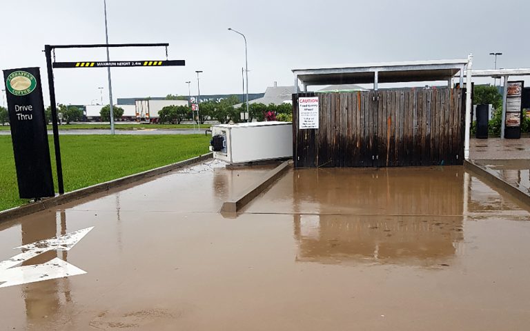 A refrigerator from the service station blocks the drive thru lane.